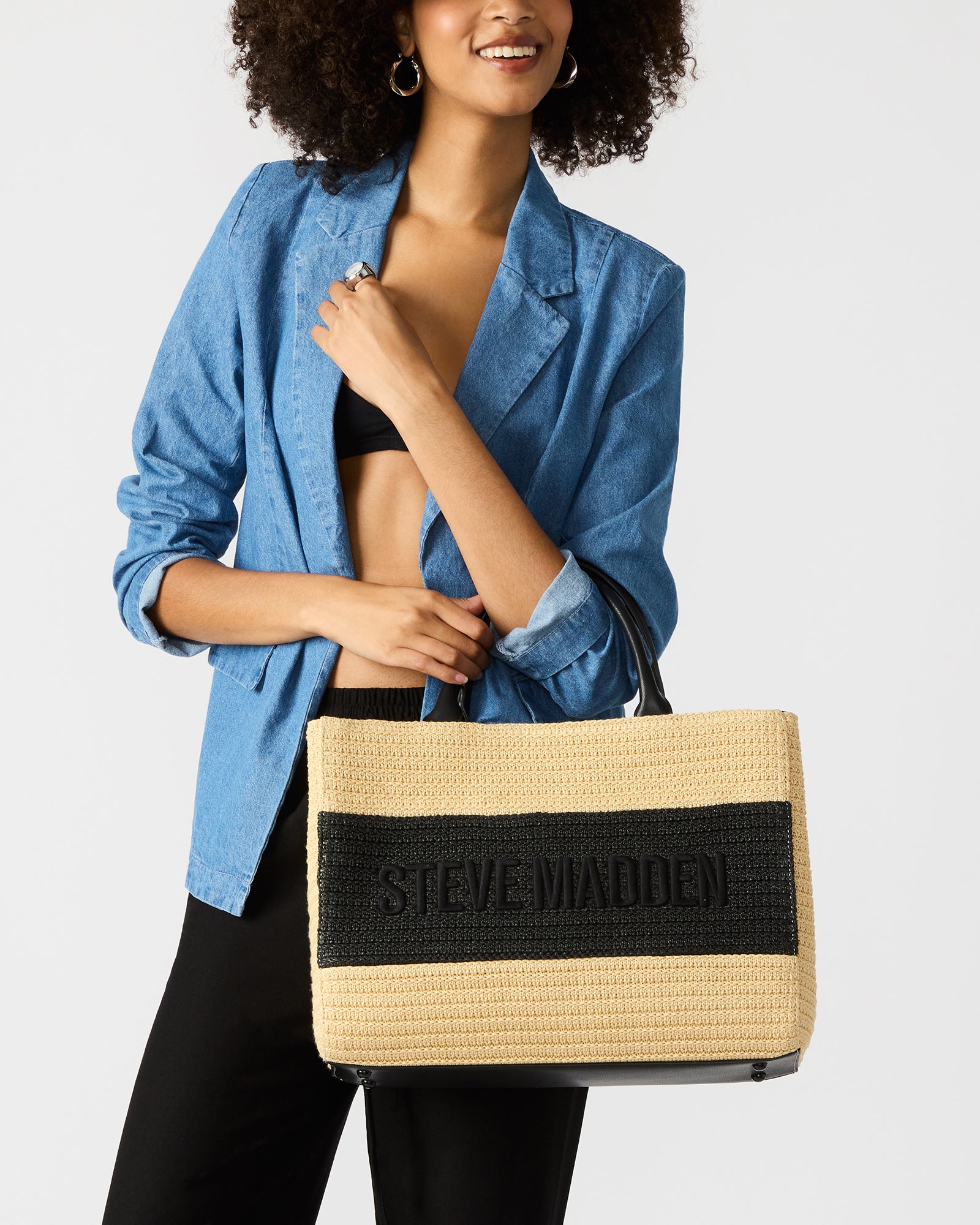 Front view of the black multi straw tote showcasing shoulder strap and detachable pouch.