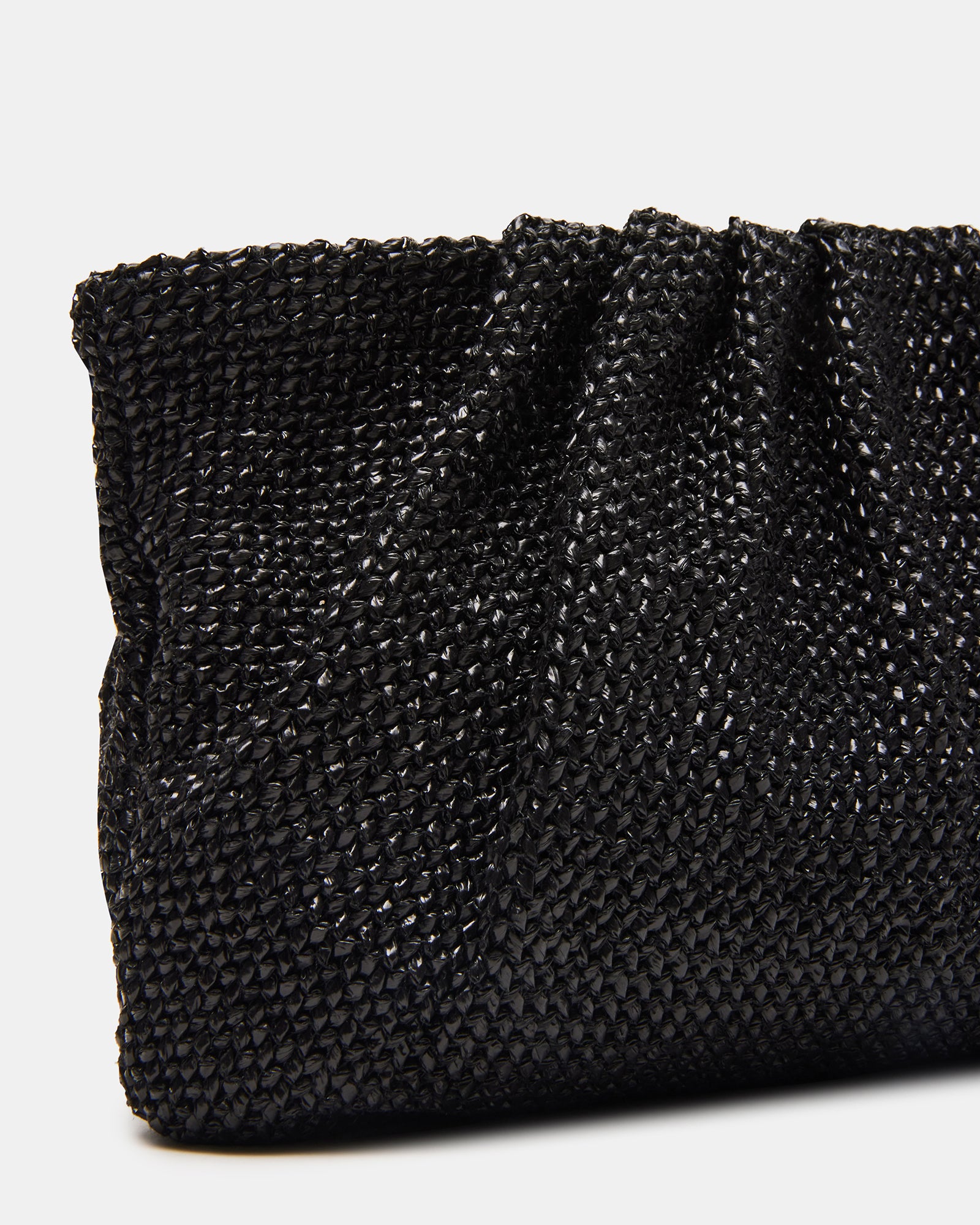 Lucia raffia clutch bag styled with a casual outfit for a chic look.