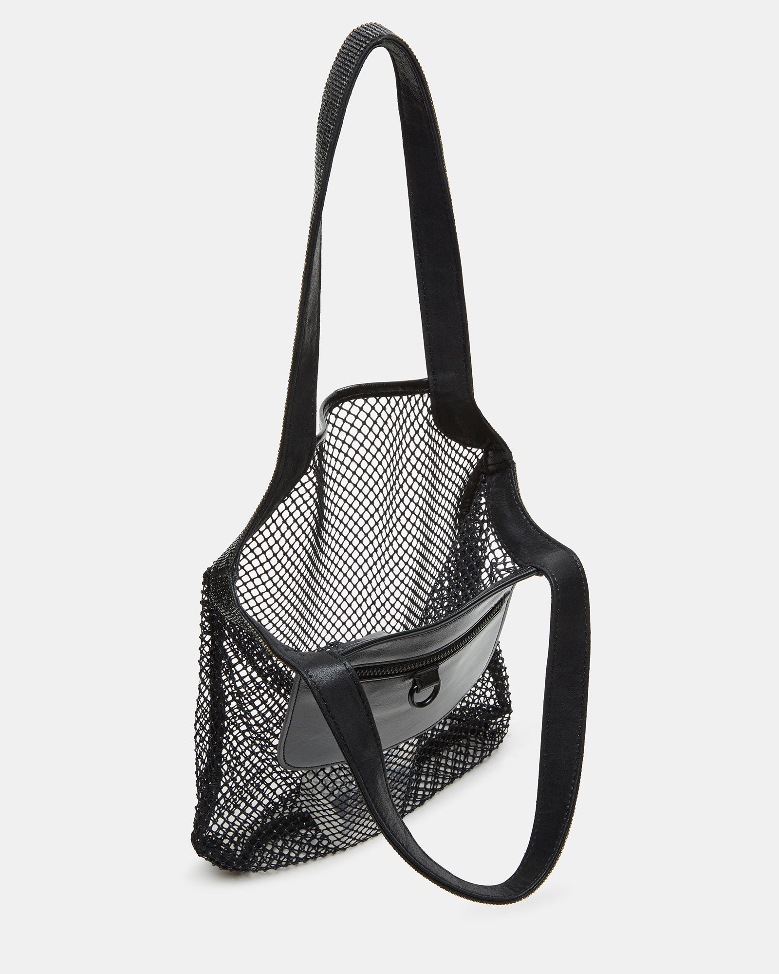Stylish black coach shoulder bag displayed on a table with accessories.