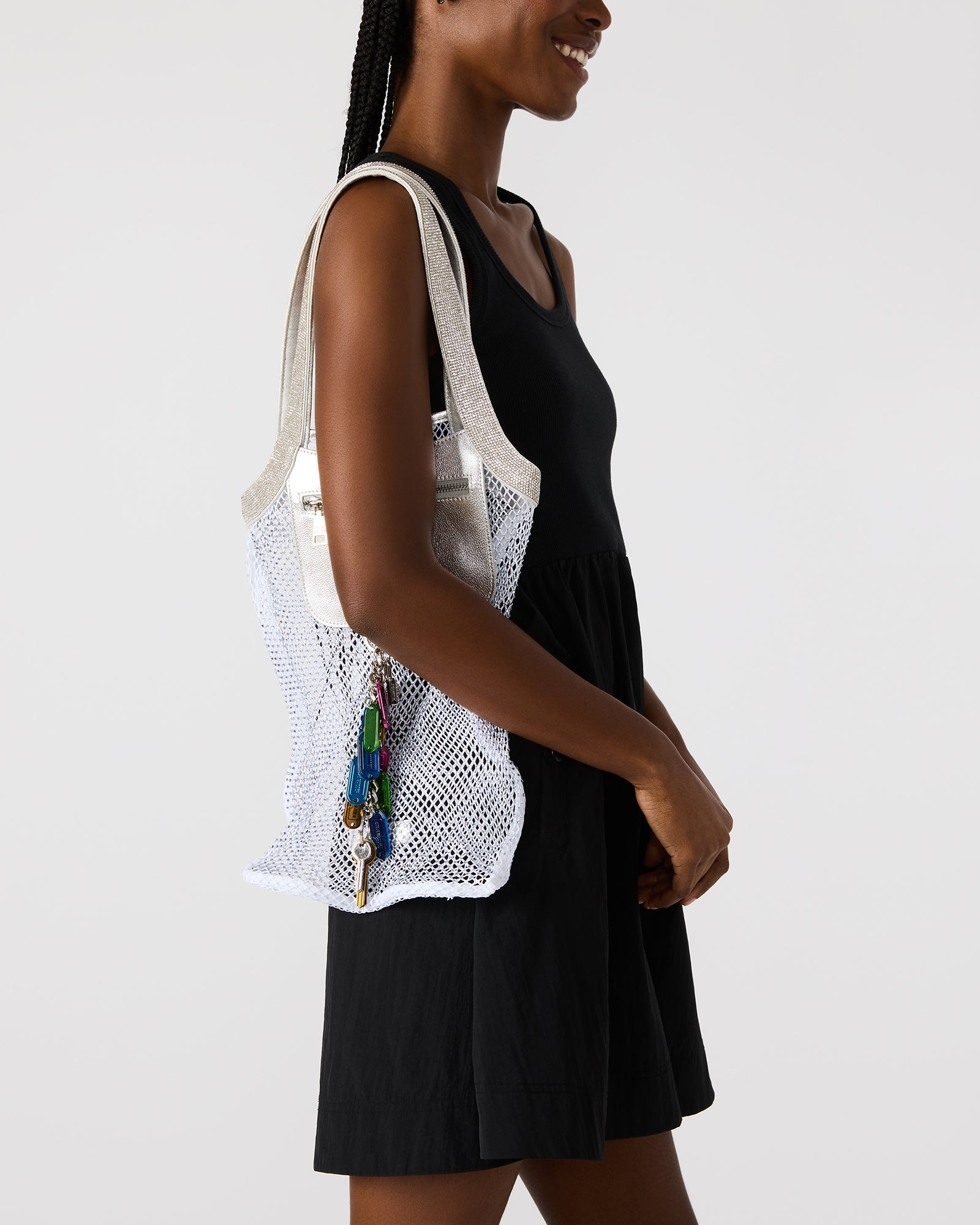 Model carrying the black and white tote bag in a city setting