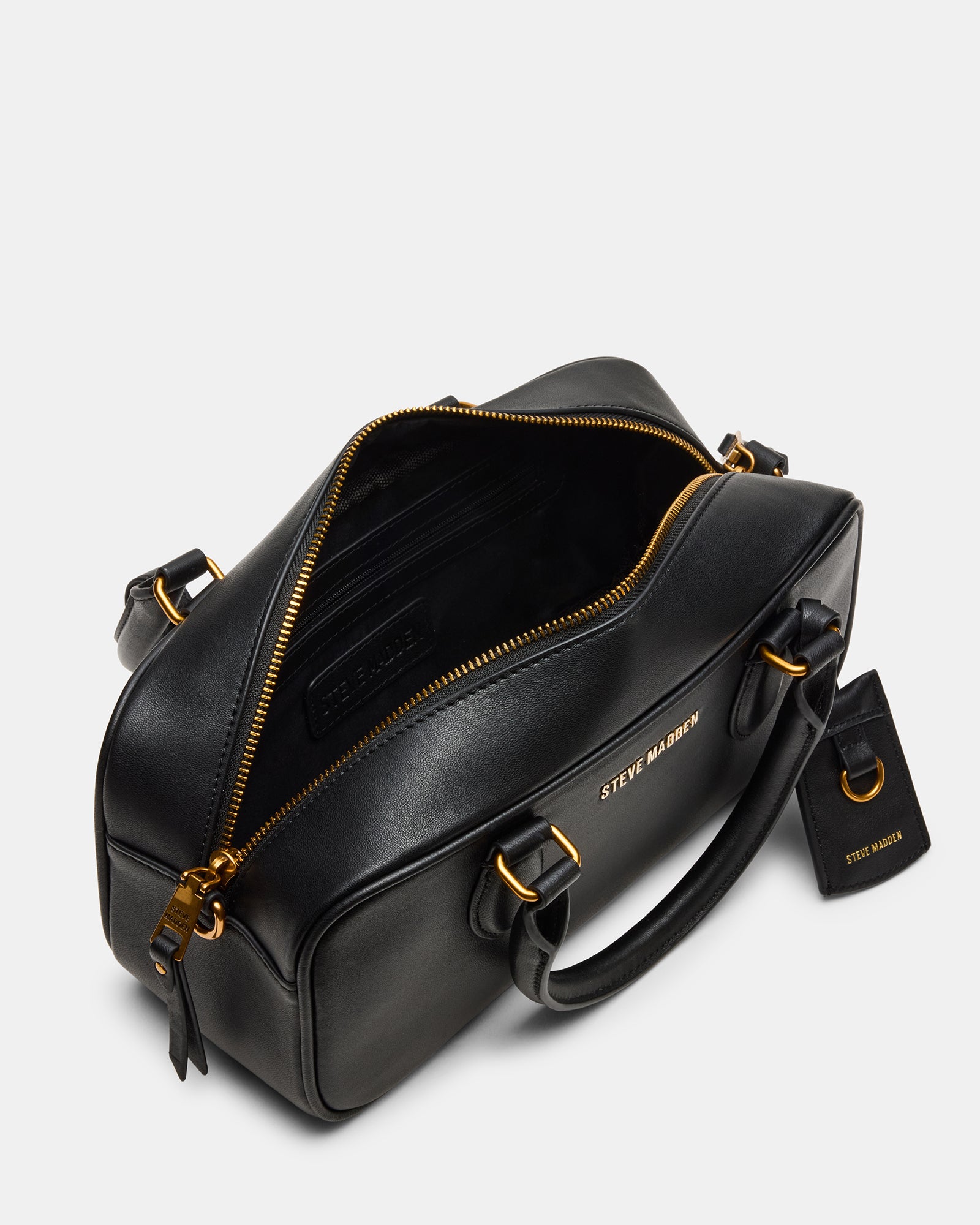 Elegant black leather crossbody bag displayed on a table.