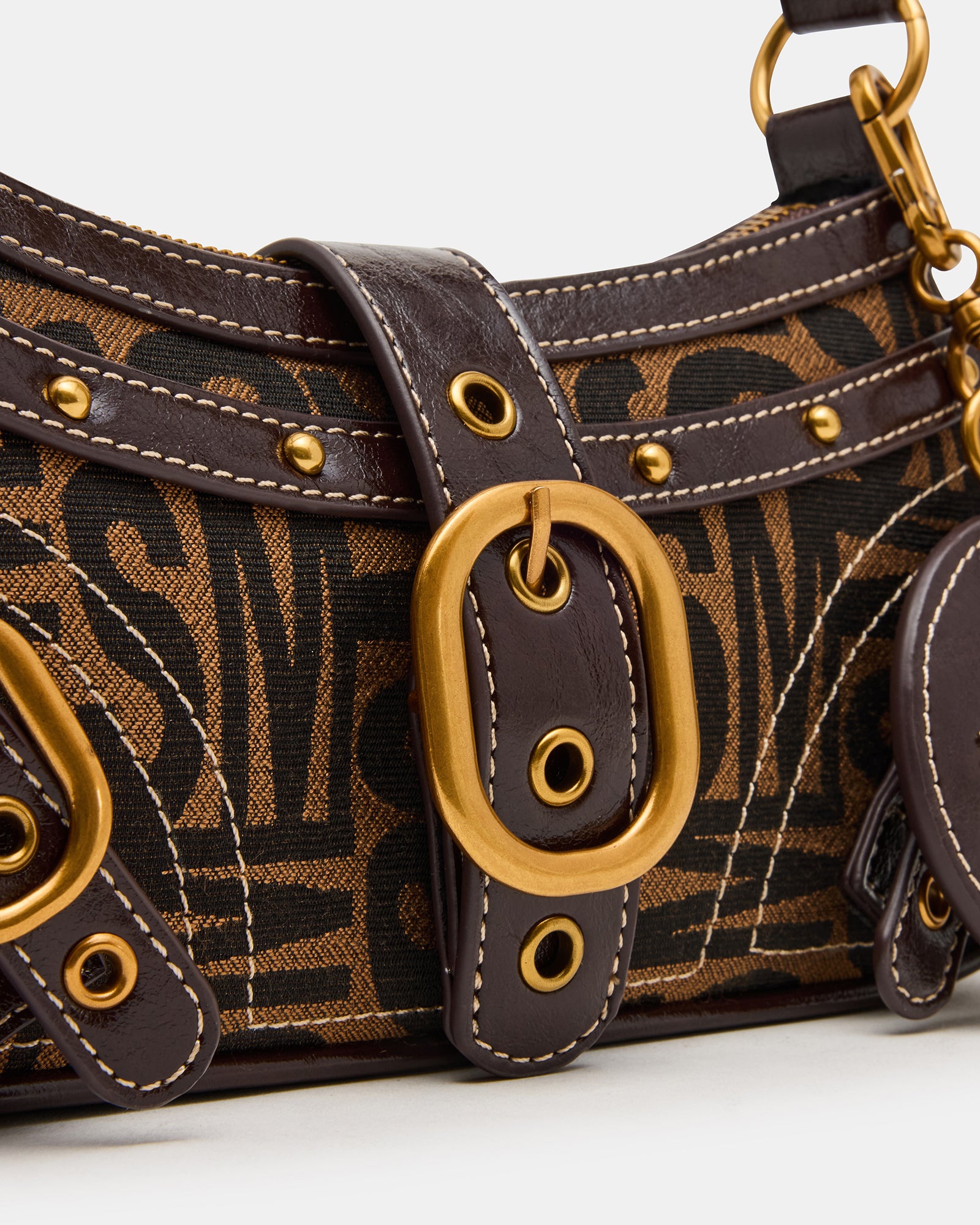 Close-up of the attachable mirror charm on the shoulder bag.