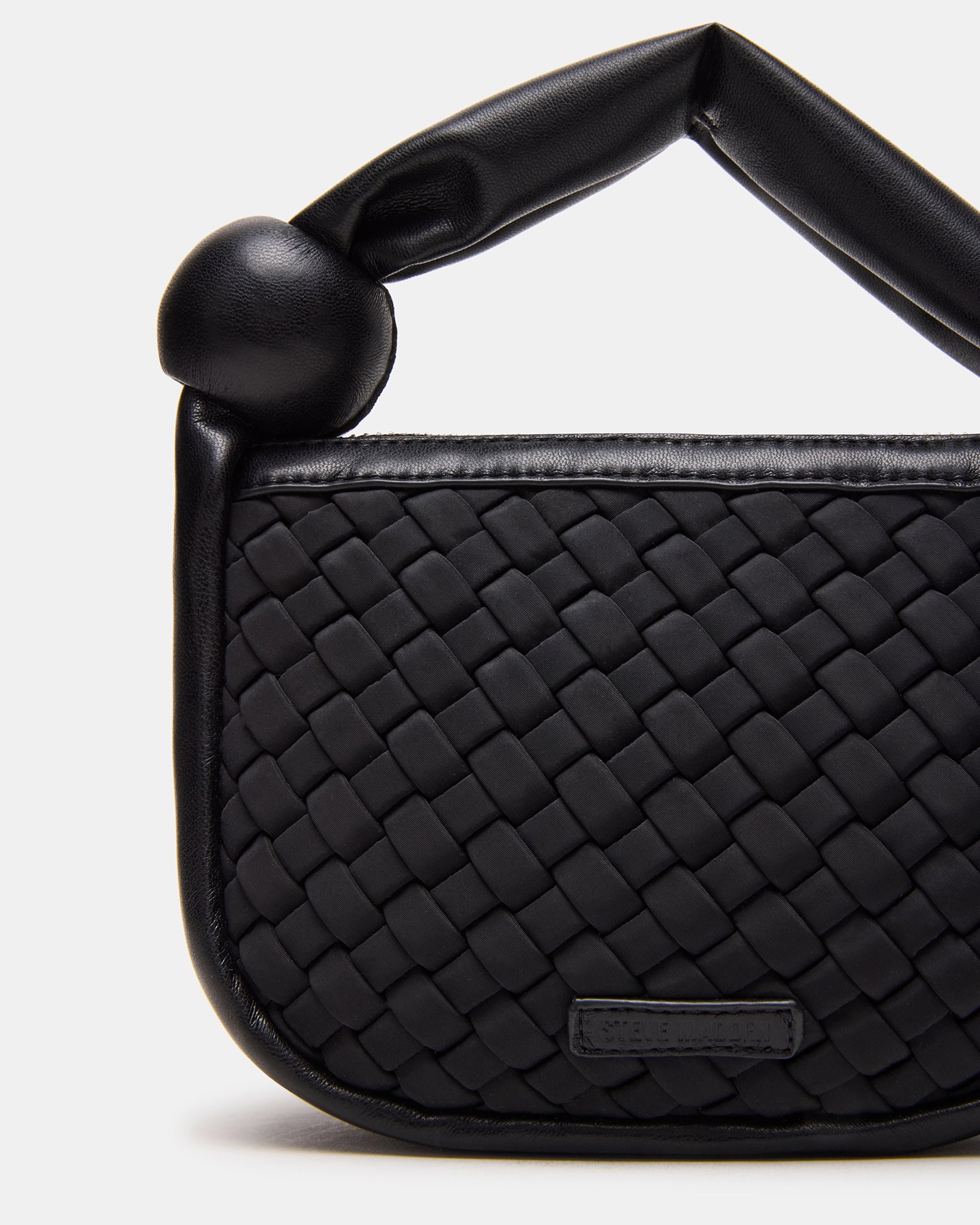 Side profile highlighting mini tote bag size and soft structure