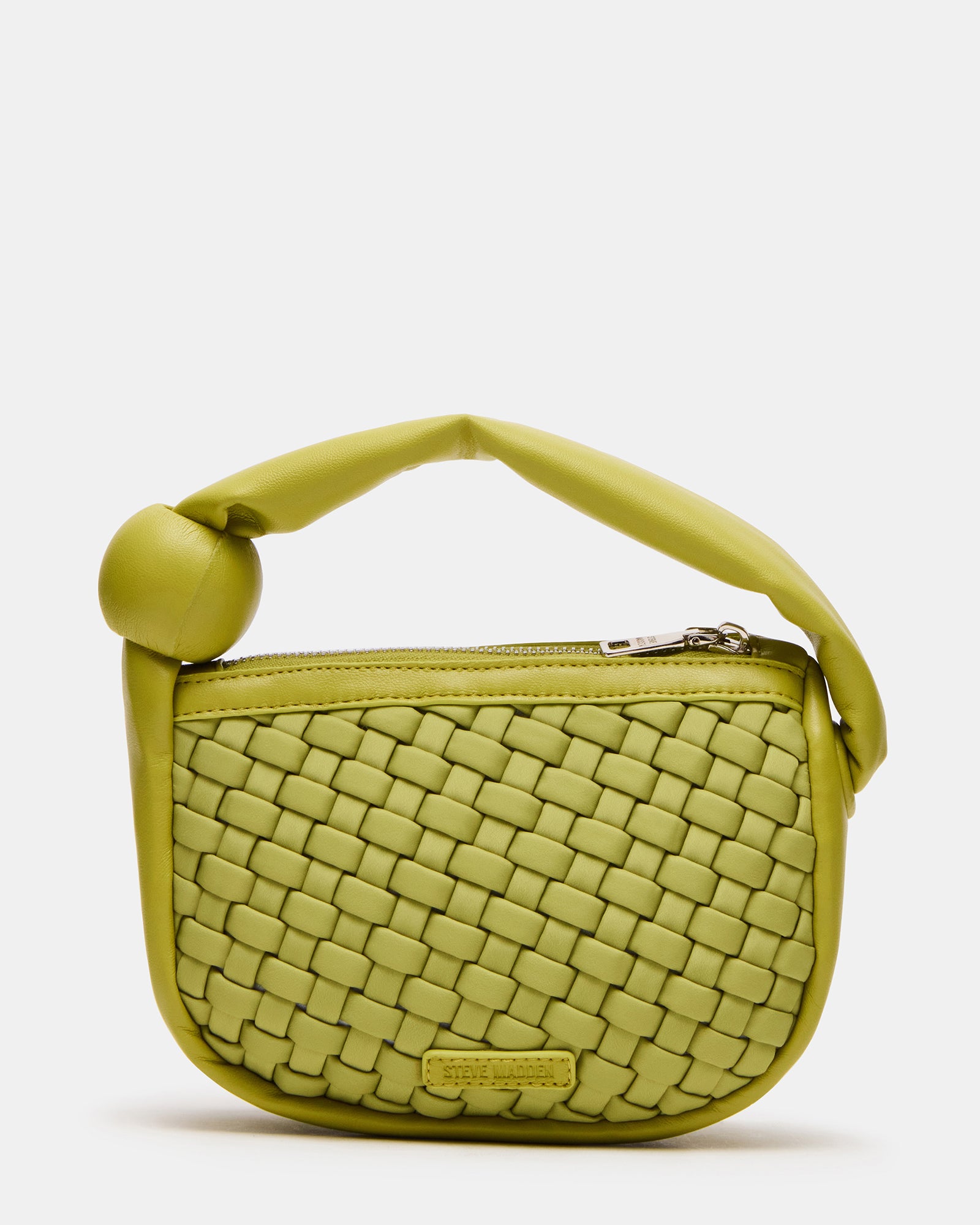 Lifestyle shot of the woven handbag being carried, highlighting its compact size.