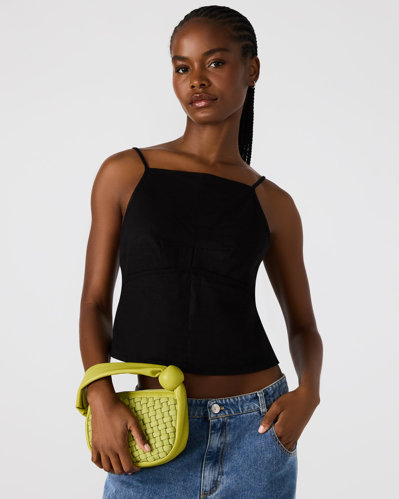 Close-up of the woven leather tote handbag showcasing the zipper closure.