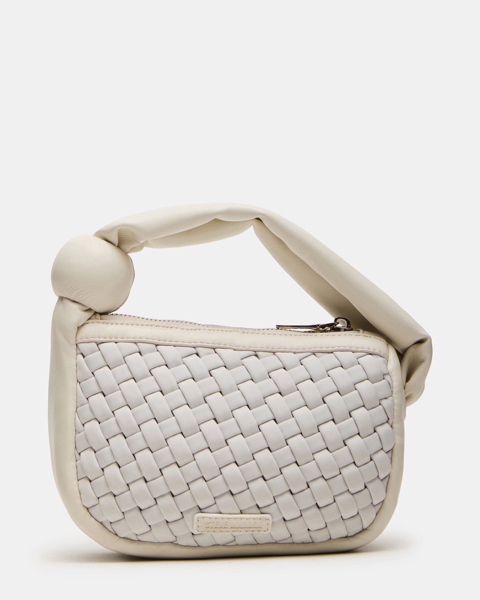 Stylish puffed handle bag in a fashionable setting.