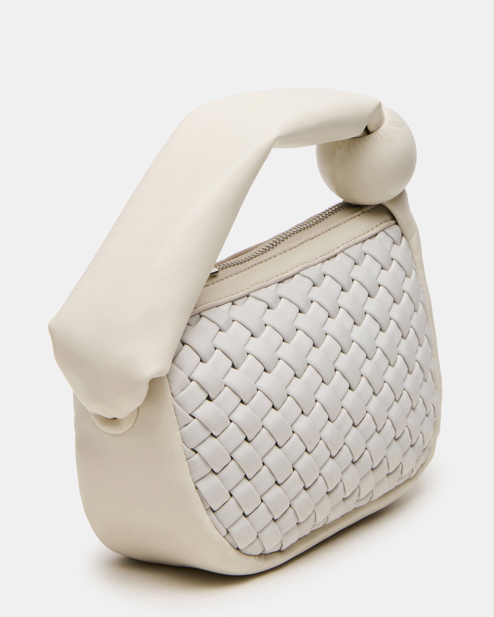 Close-up of the mini white bag with zipper detail.