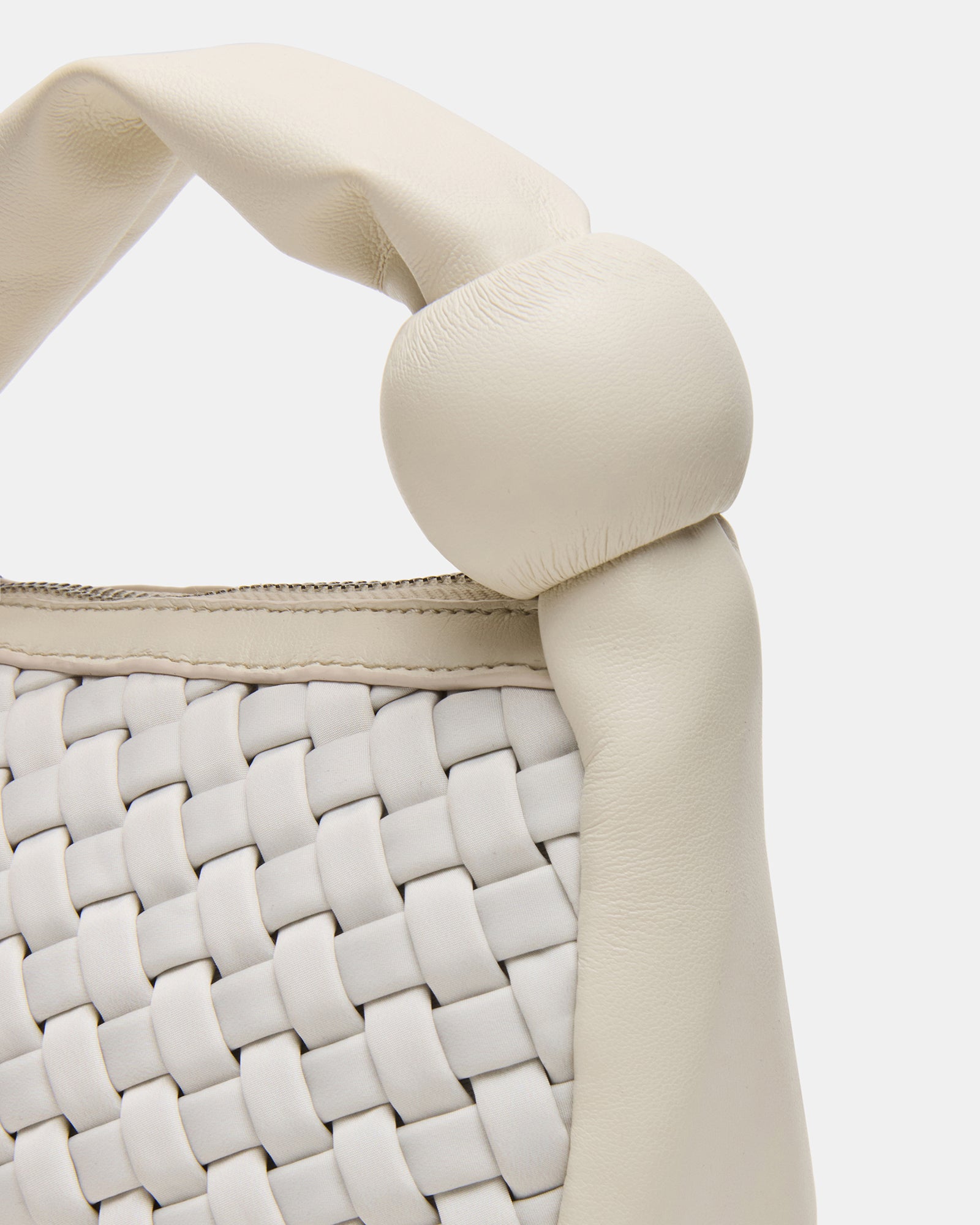 Stylish puffed handle bag in a fashionable setting.