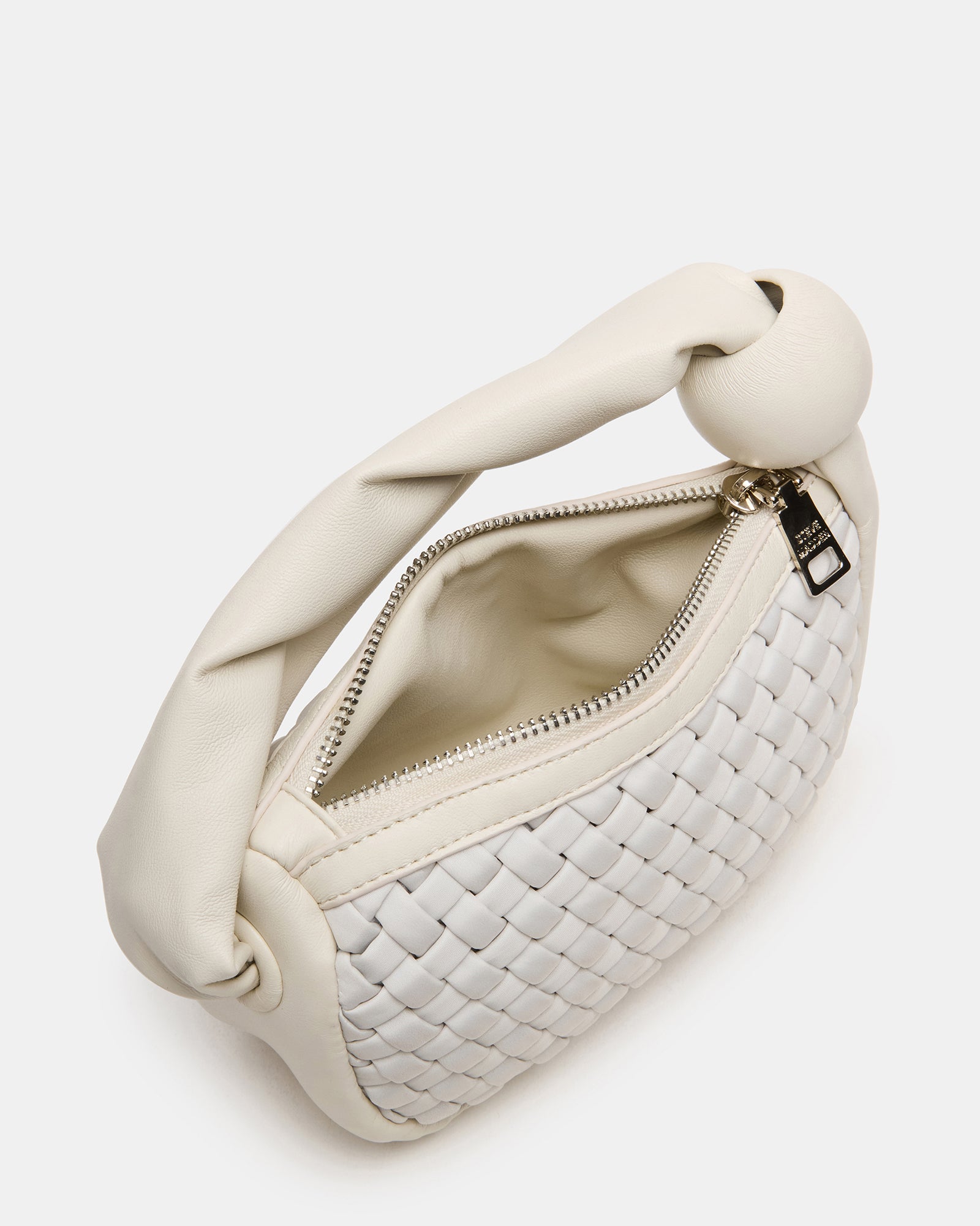 Chic white mini woven bag showcased on a table.