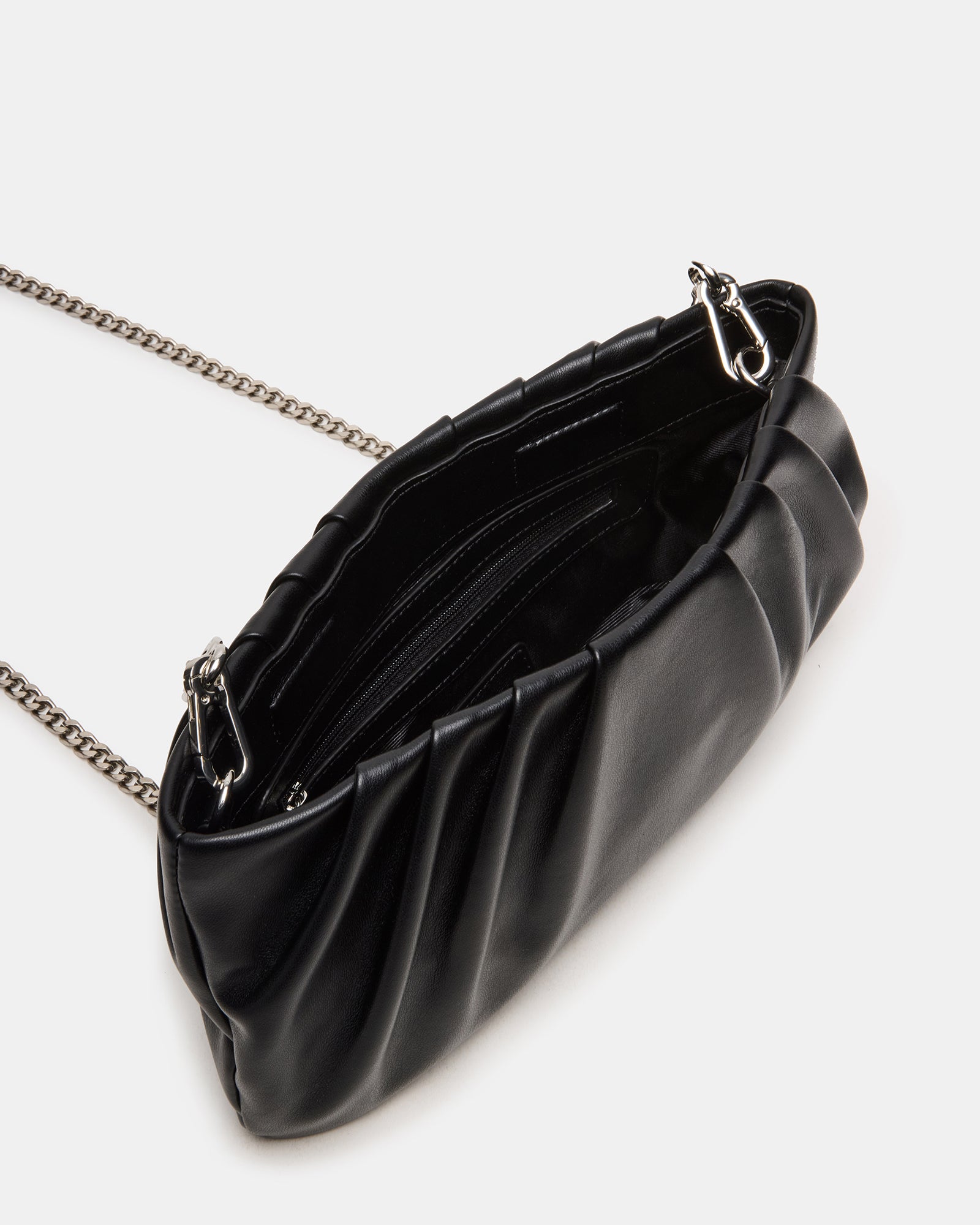 Interior of clutch bag showing zippered pouch and roomy compartment