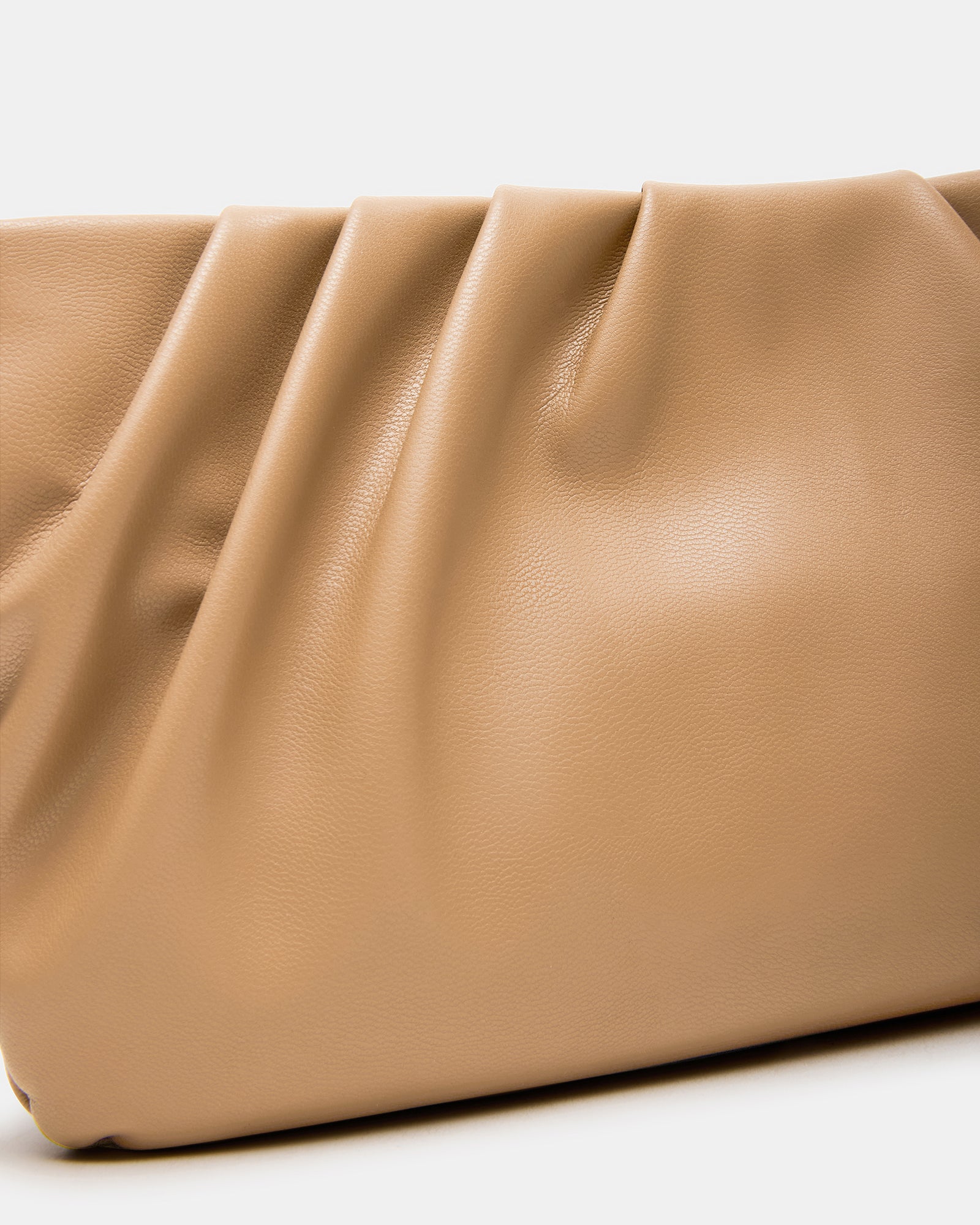 Close-up of magnetic snap closure and pleated exterior detail on the NIKA bag