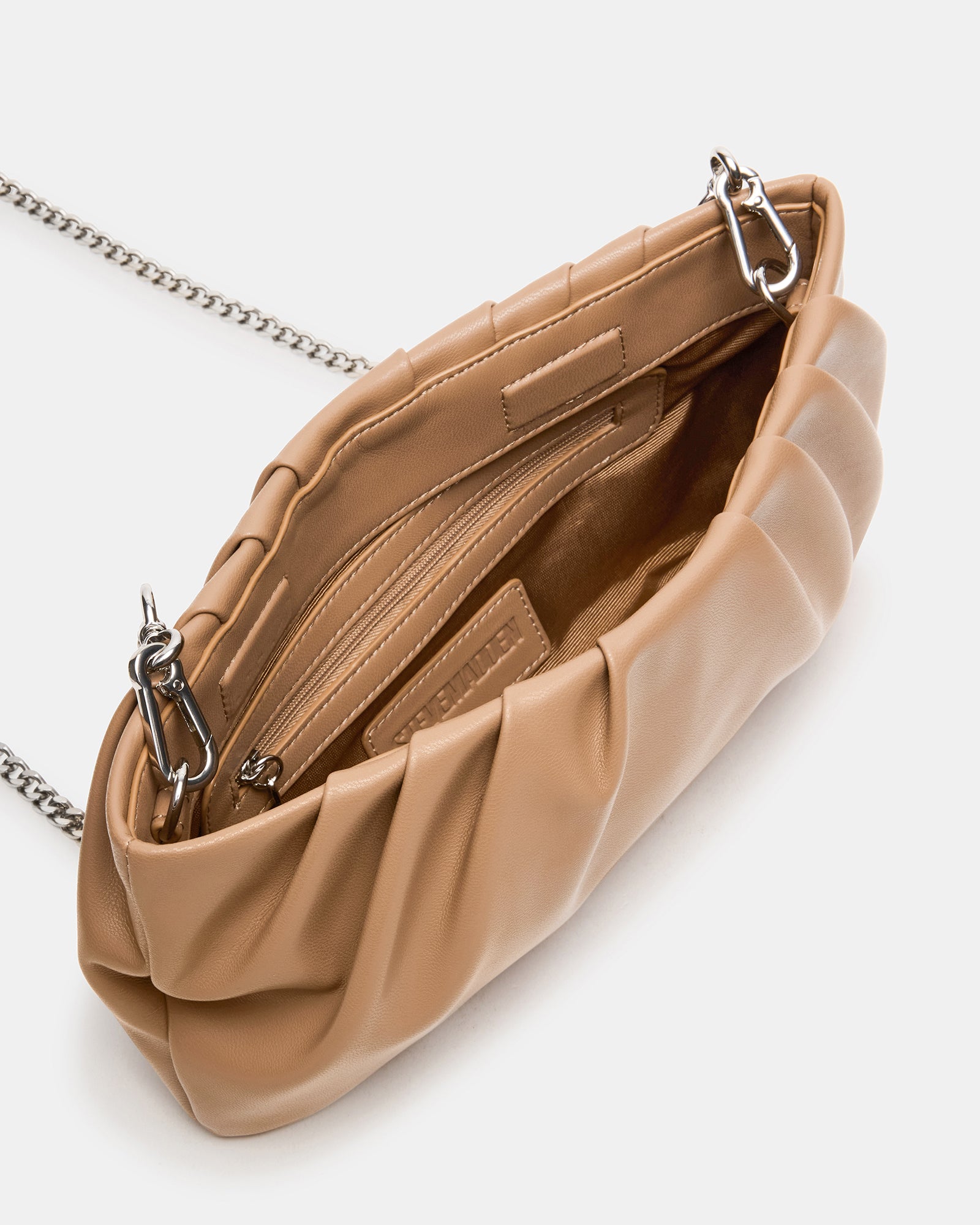 Interior shot of the NIKA clutch showing zipper pouch and spacious design for essentials