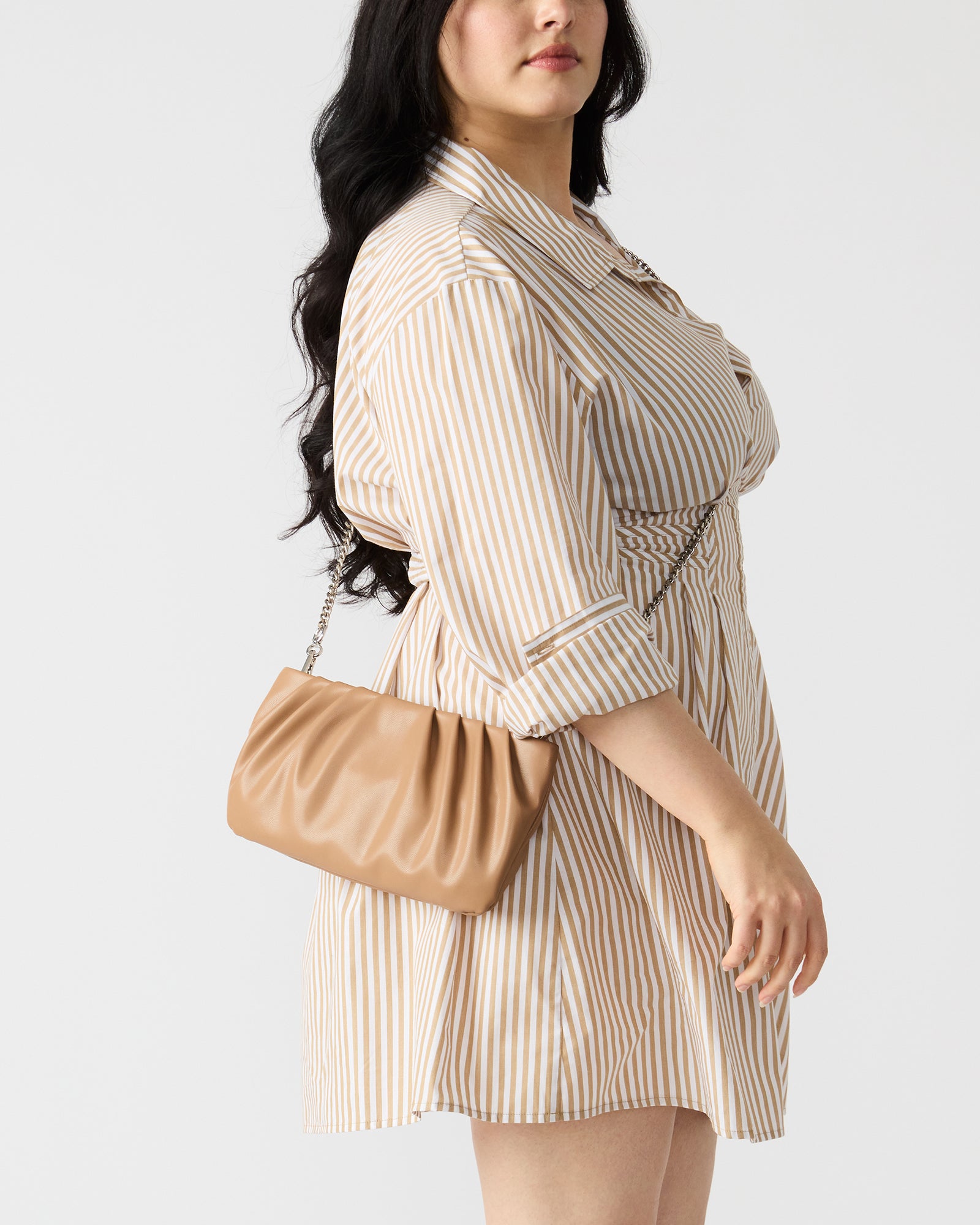 Interior shot of the NIKA clutch showing zipper pouch and spacious design for essentials