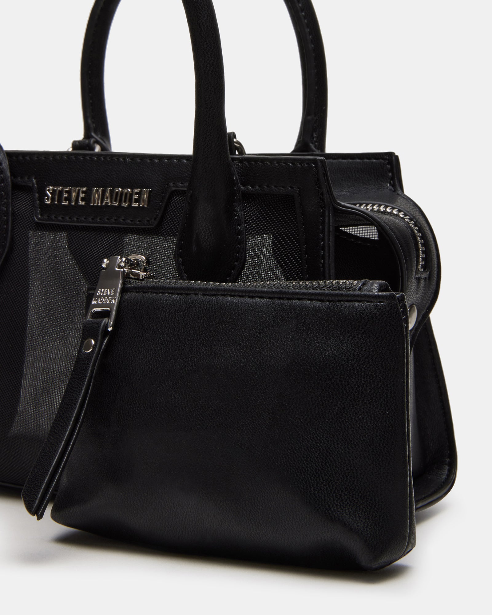 Model wearing the black mesh handbag at a social event