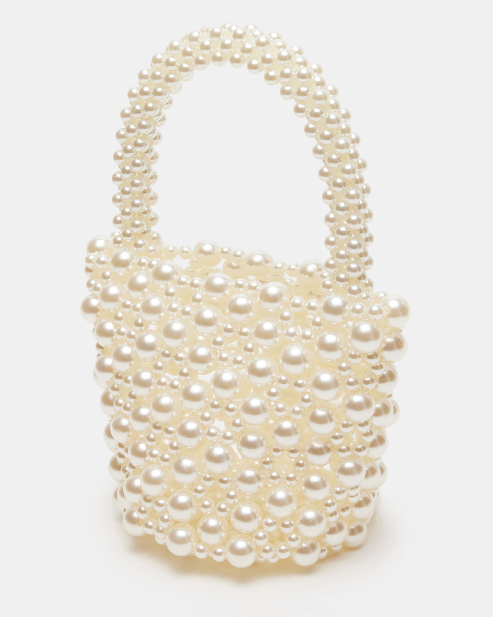 Close-up of faux pearl handle on ivory bucket bag, showcasing pearl detailing