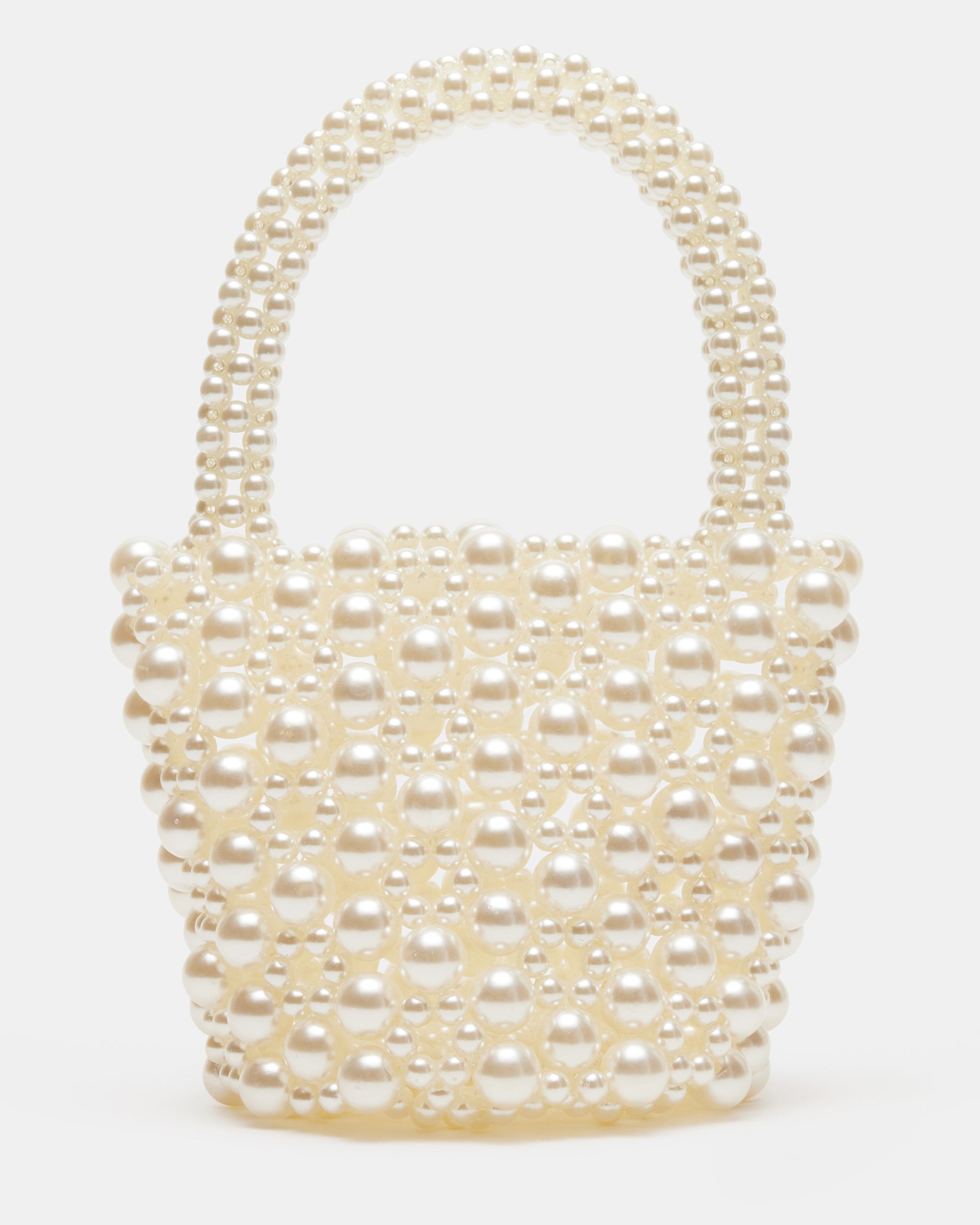 Flat lay of ivory purse alongside pearl accessories for a luxe styling session