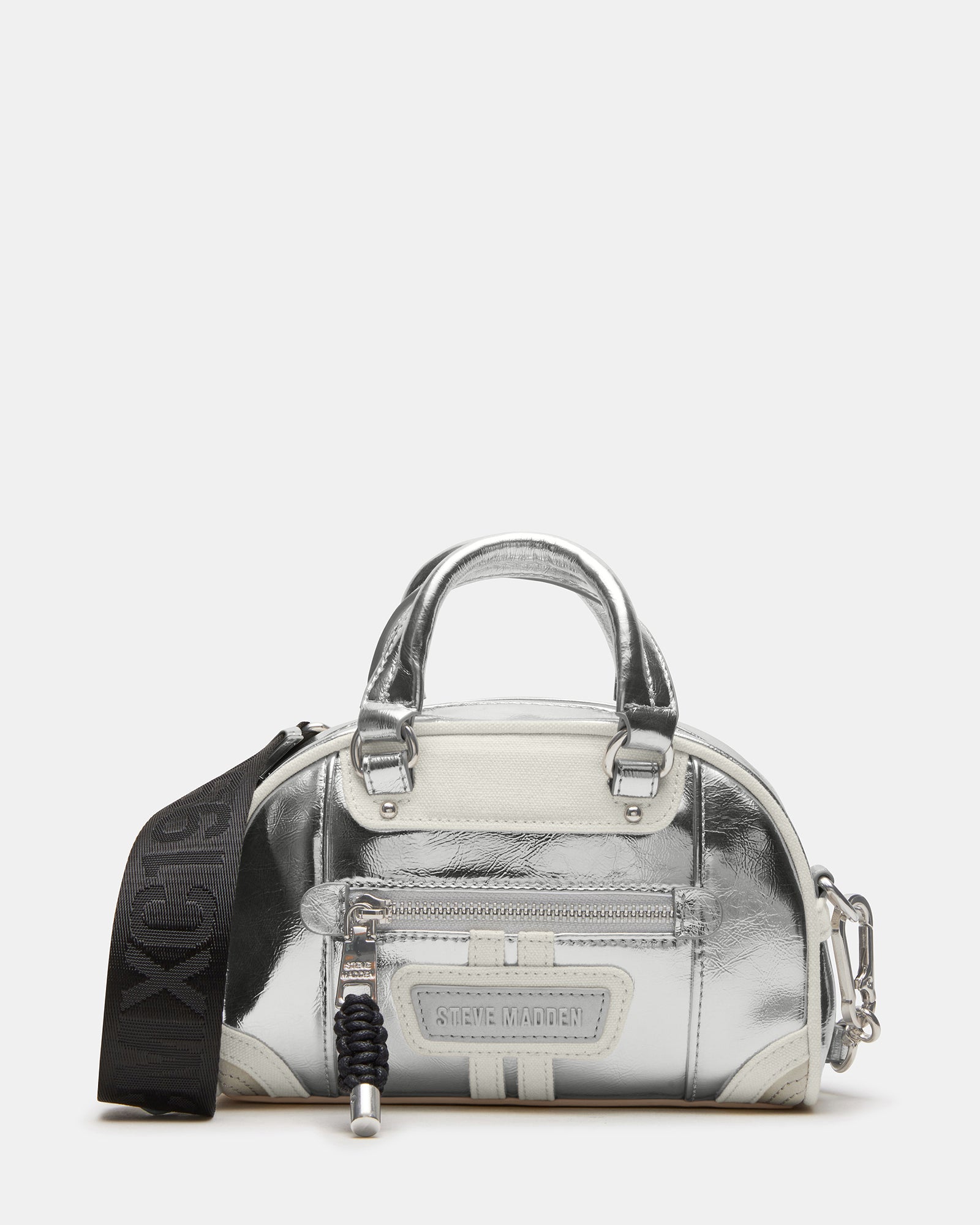 Close-up of the silver dome crossbody bag's bungee zip and embossed logo patch