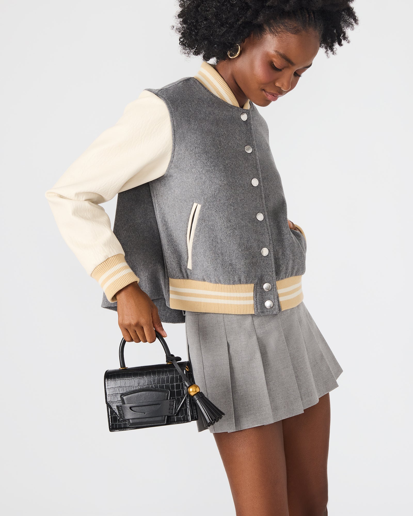 Close-up of the chic black handbag showcasing its accordion gusset.