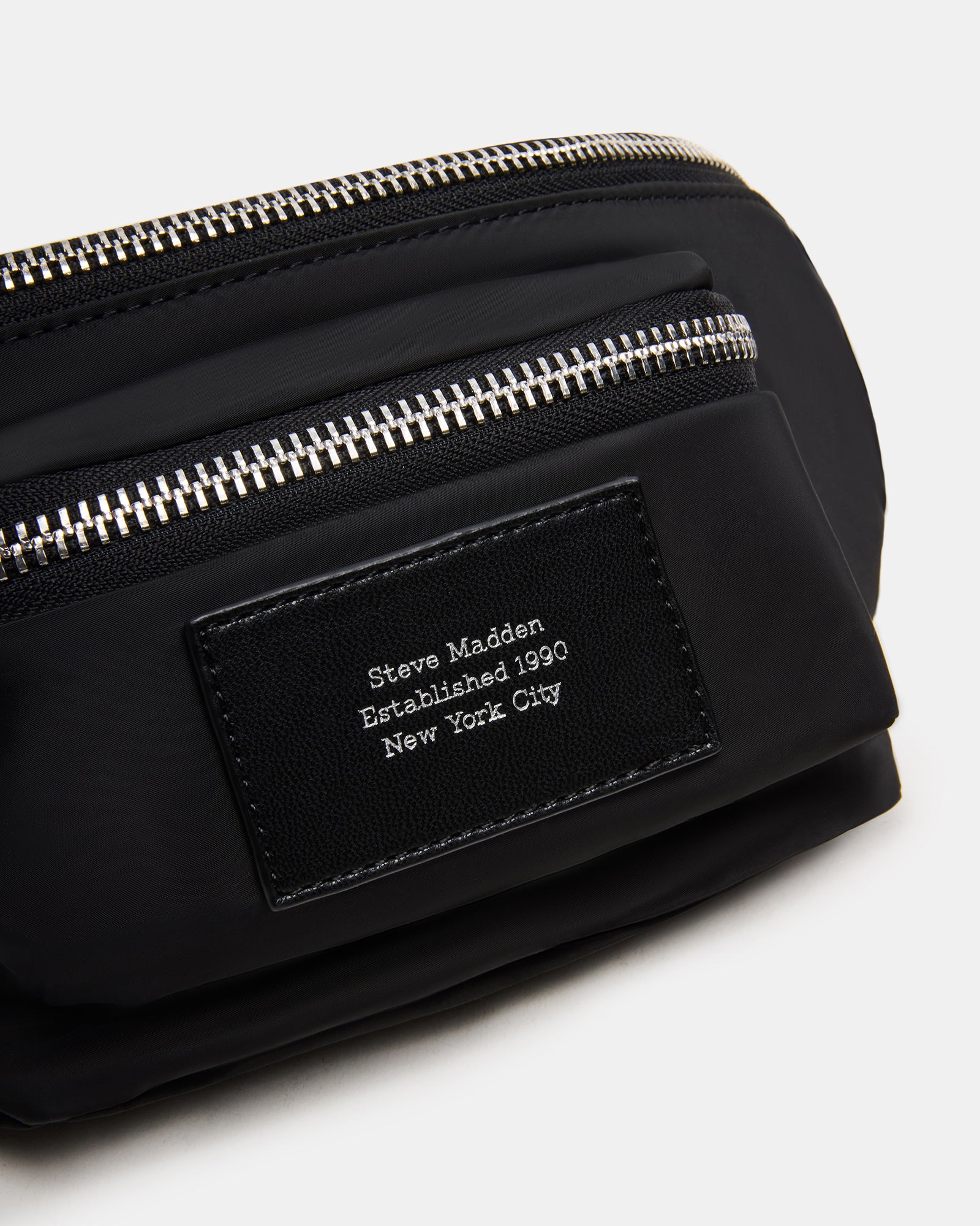 Close-up of embossed foil logo patch on the Remix Bag Black