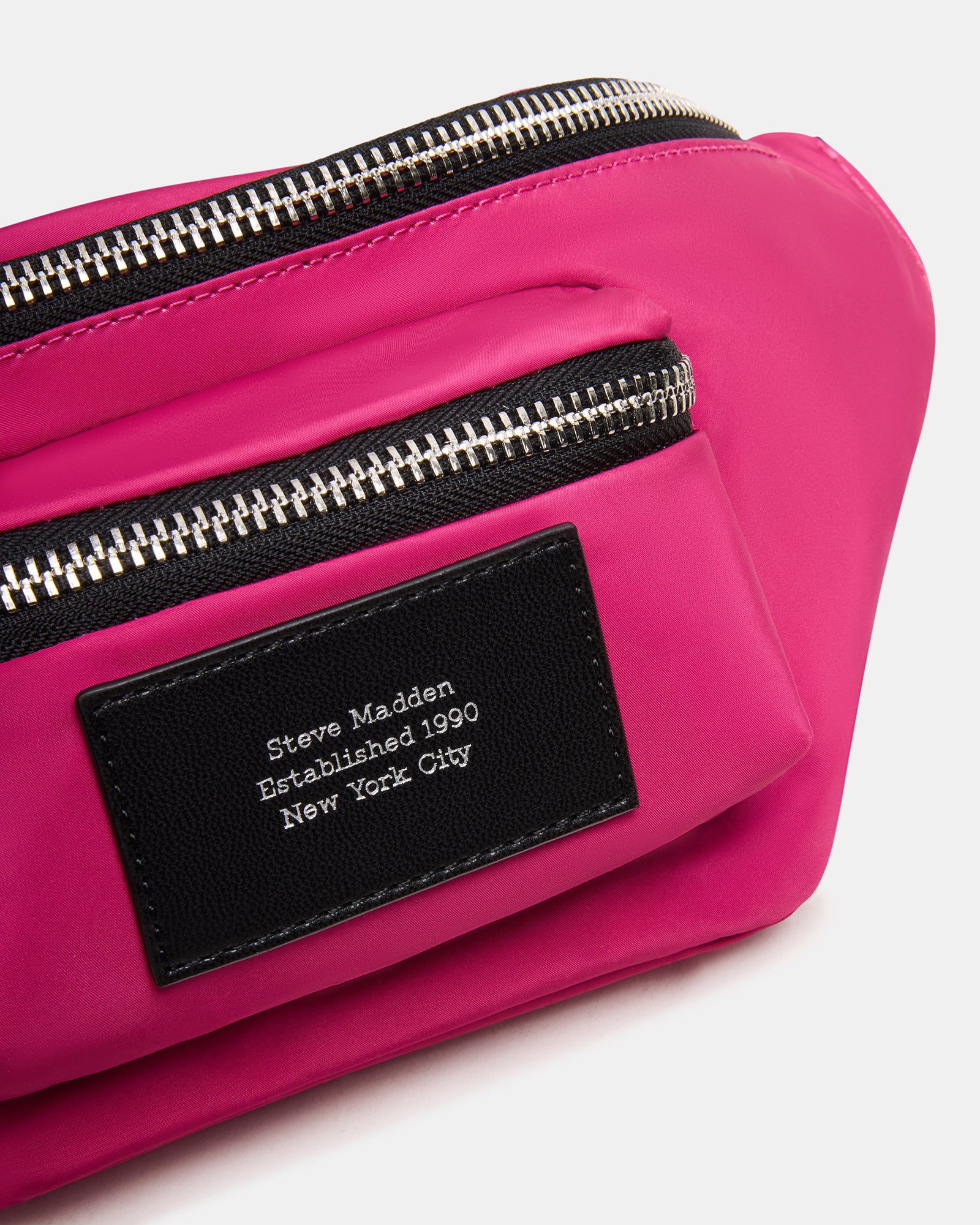 Remix fuchsia belt bag worn as a sling across casual summer outfit