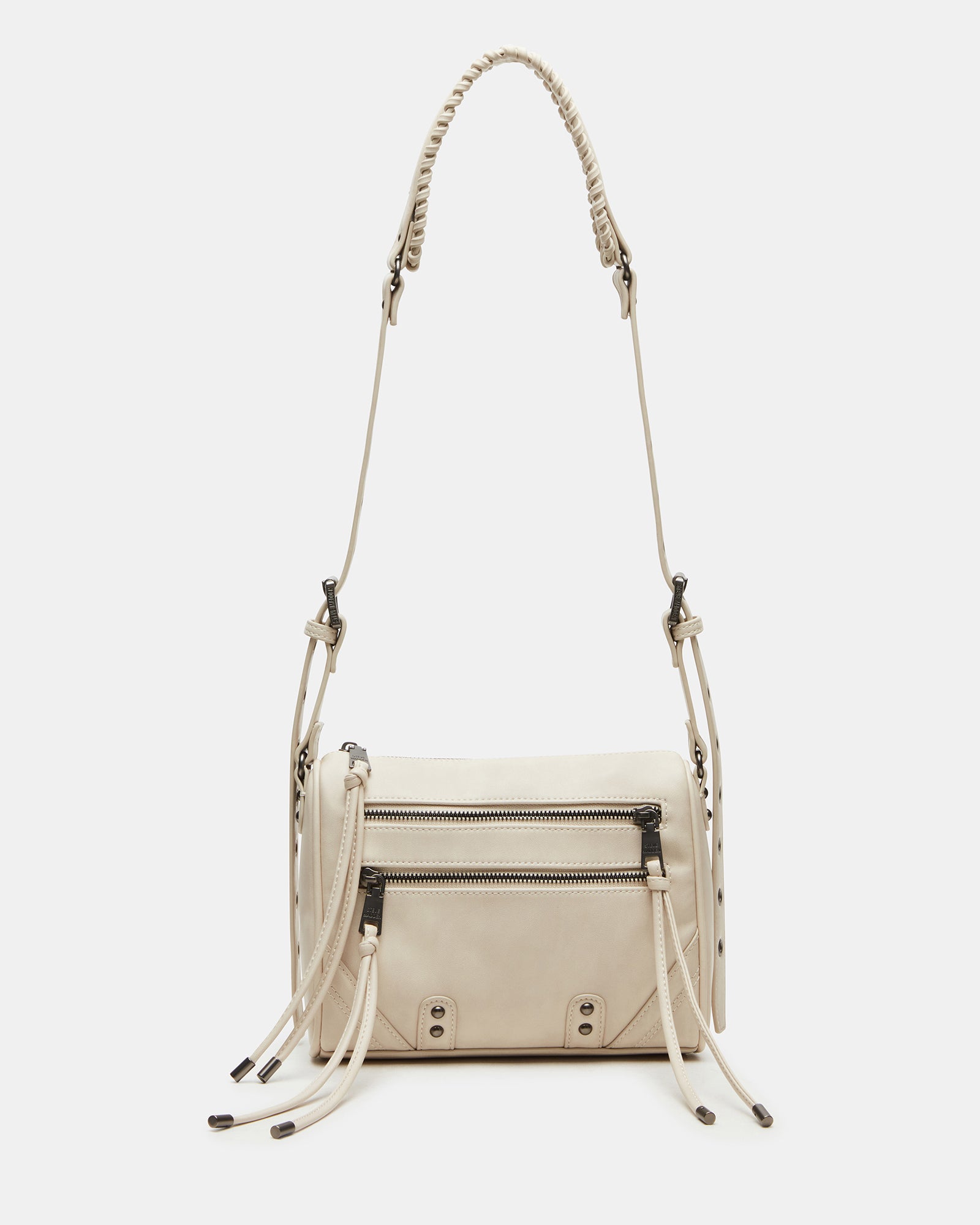Close-up of the RIGBY taupe crossbody bag showing stud and fringe details