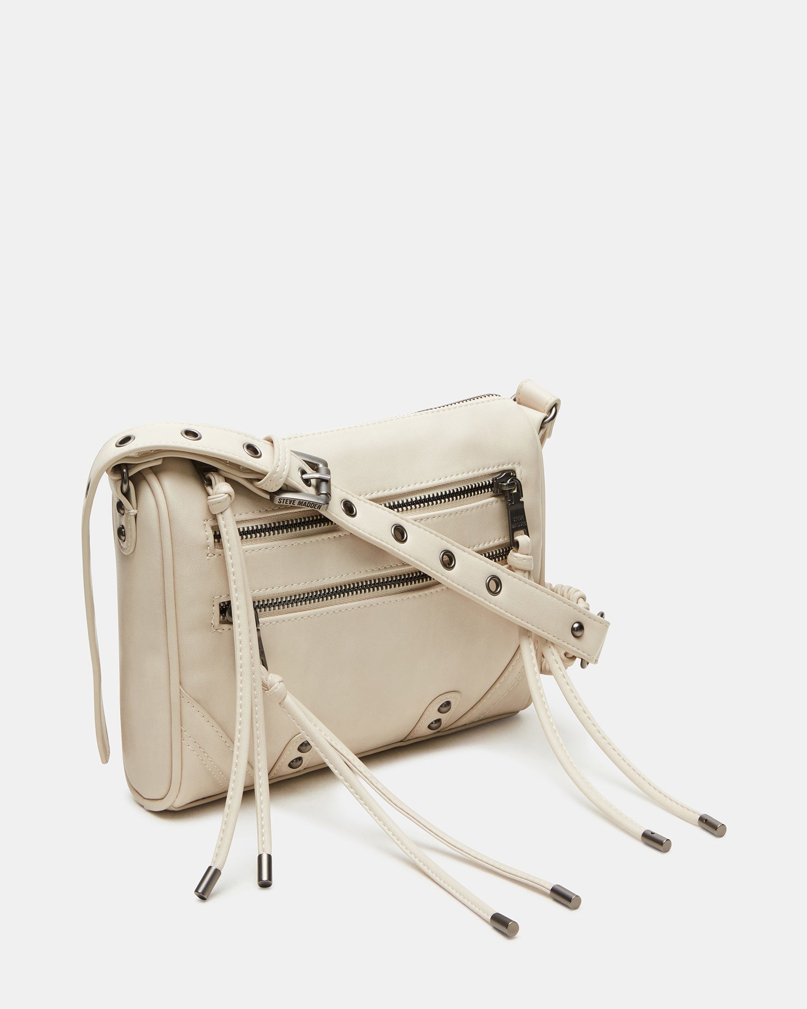 Close-up of the RIGBY taupe crossbody bag showing stud and fringe details