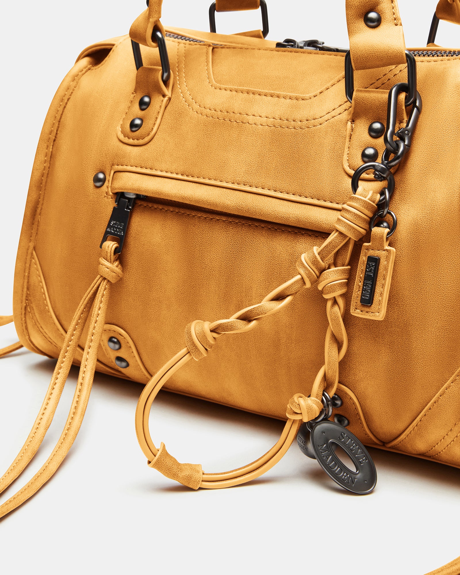 Styled with a casual outfit, showcasing the versatile top handle and crossbody strap