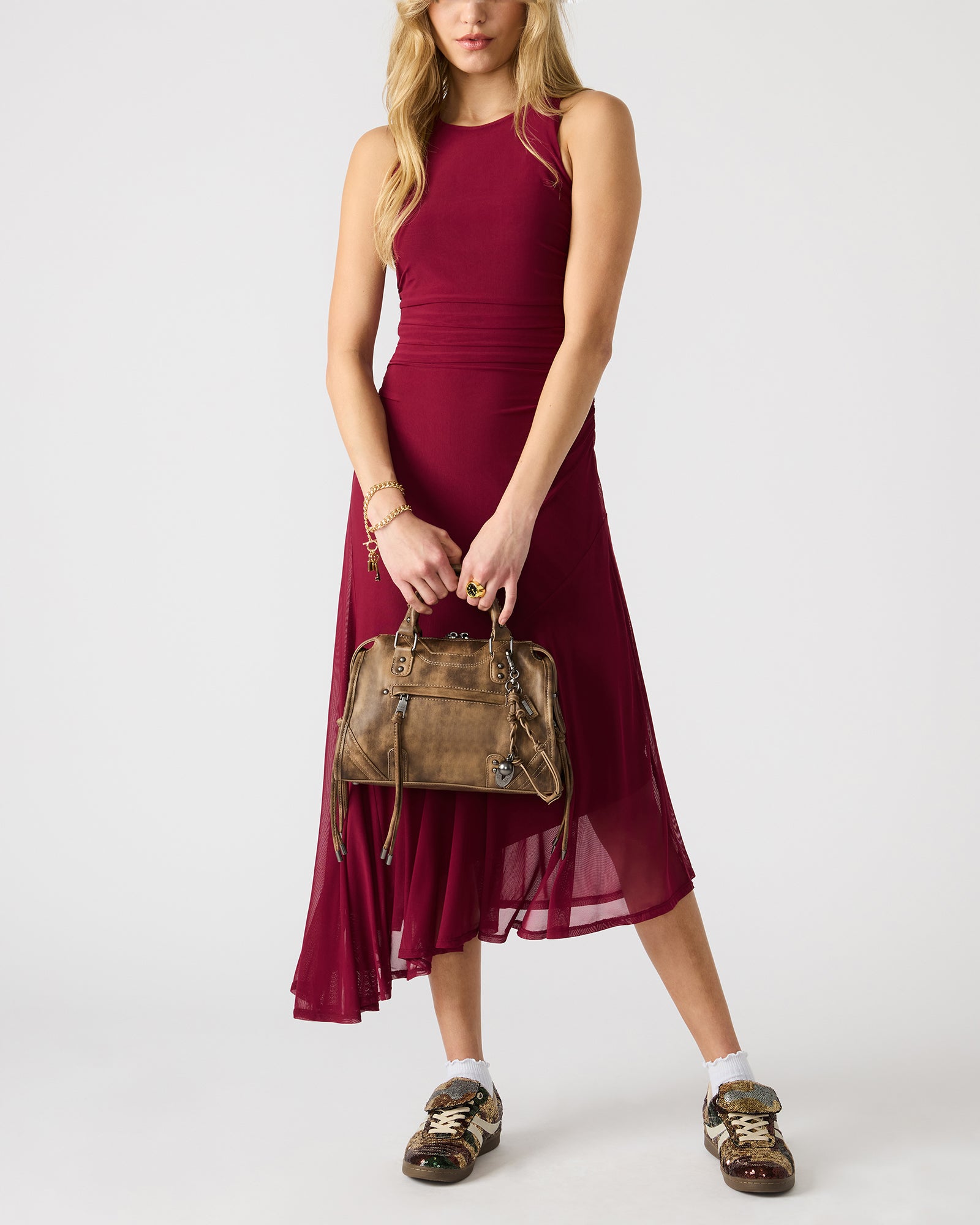 Slouchy satchel bag worn crossbody in an urban setting