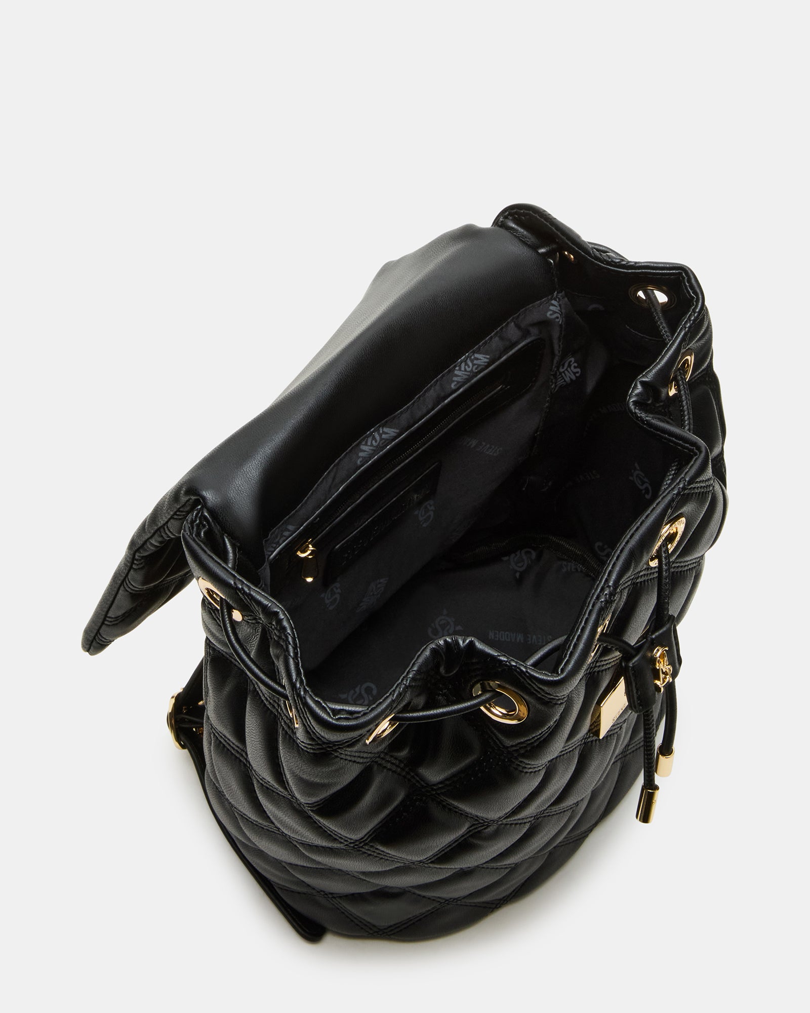Interior shot showing spacious compartment and back pouch of the quilted backpack