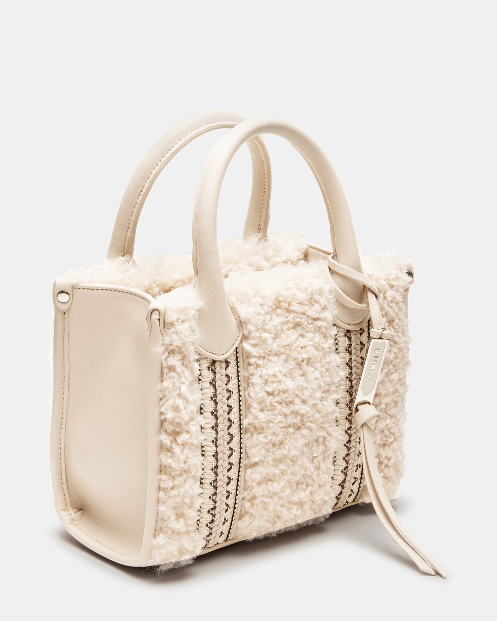 Close-up angle of the Sherpa box bag showing textured braid detail and logo charm.