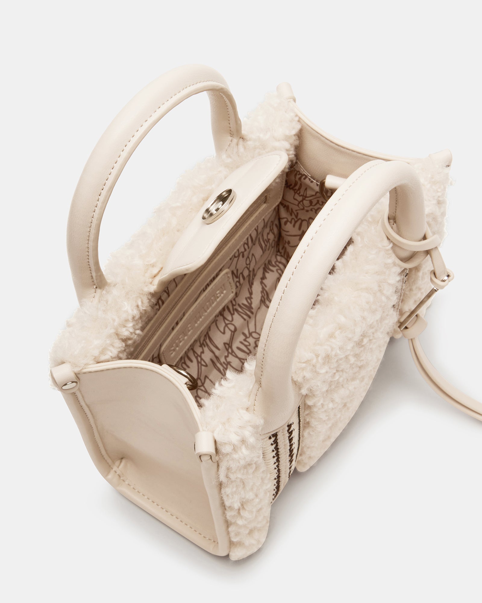 Side profile of the mini bag with detachable strap laid out for crossbody styling.