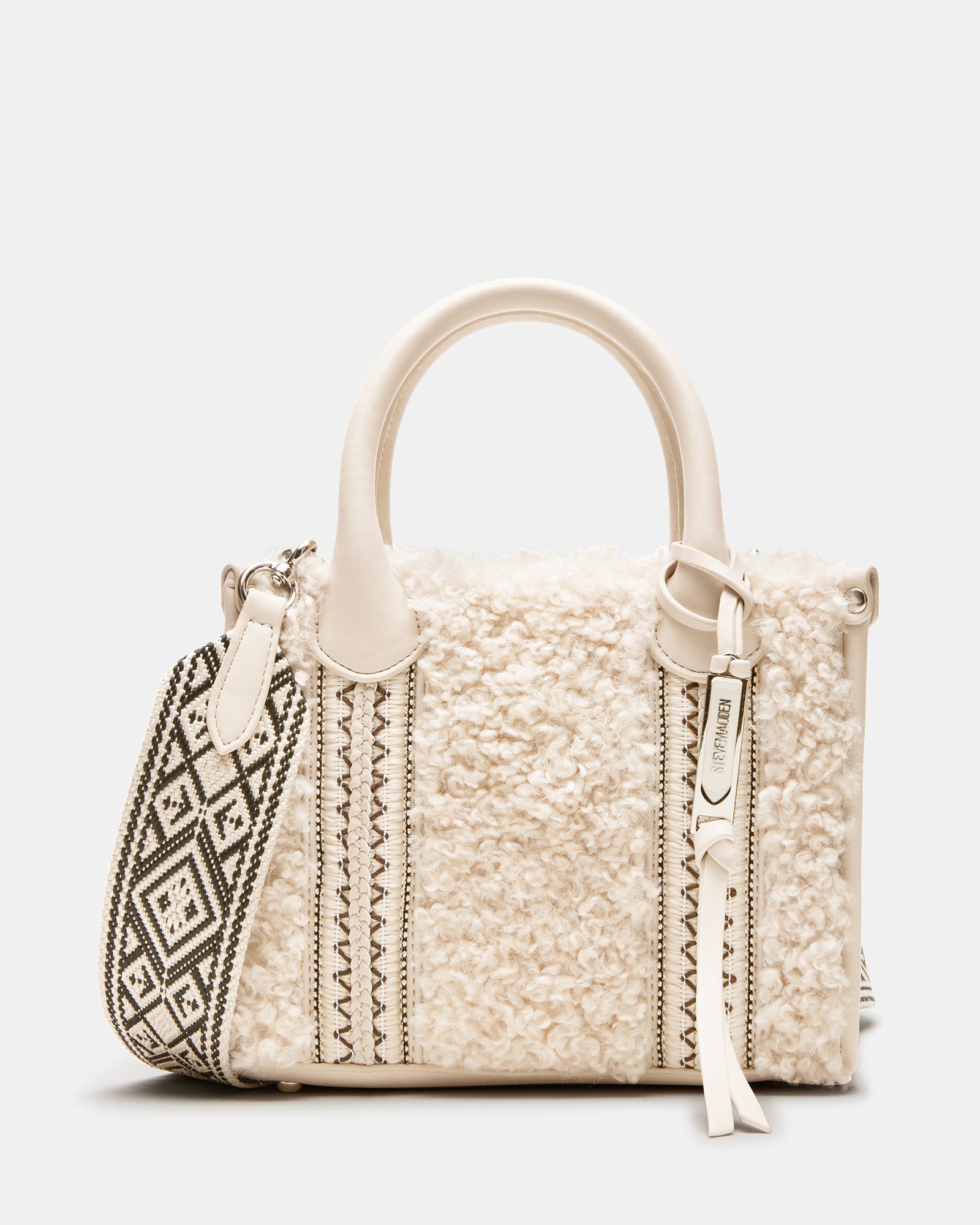 Close-up angle of the Sherpa box bag showing textured braid detail and logo charm.