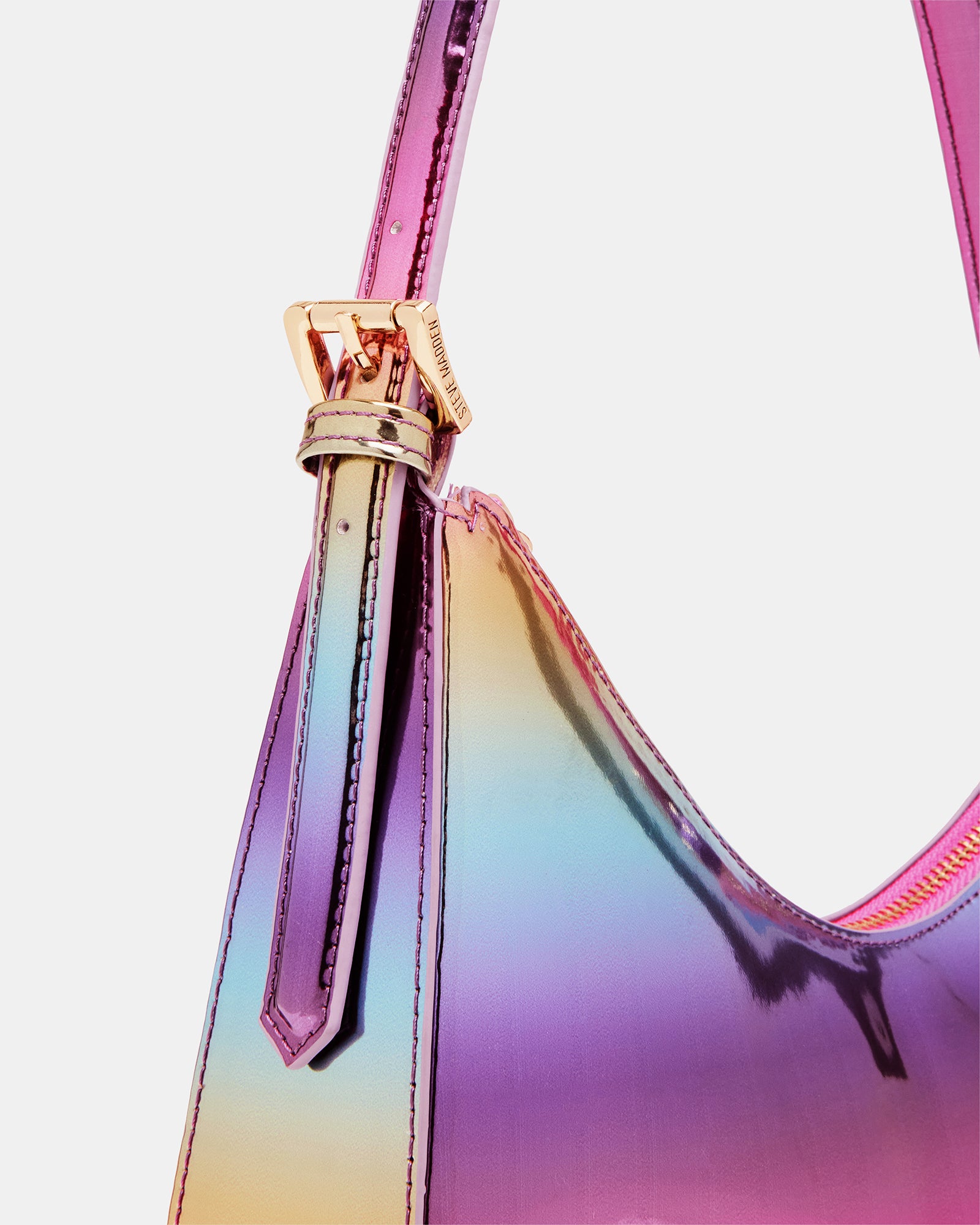 Close-up of adjustable strap and top zipper, emphasizing functional details of the asymmetrical bag.