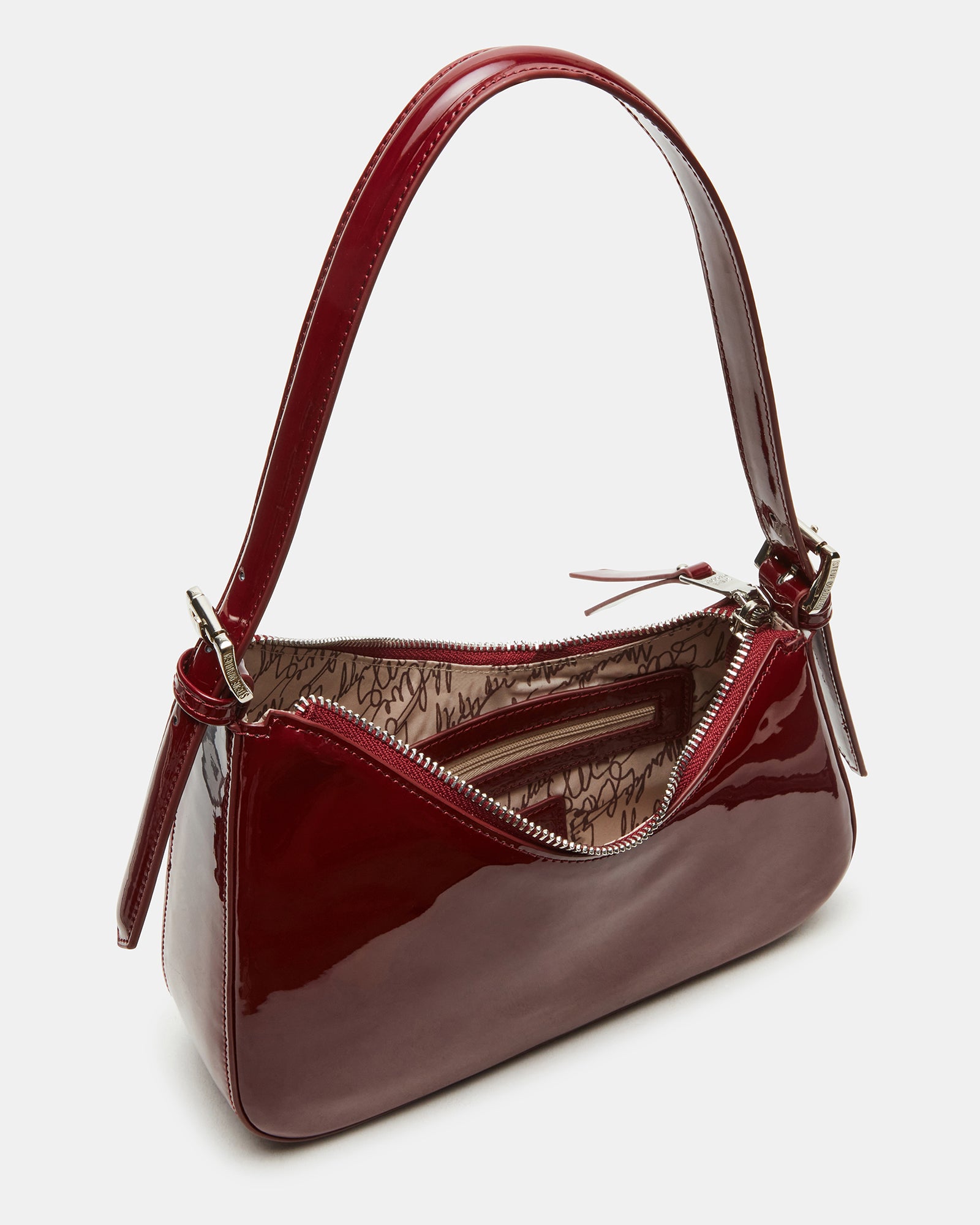 Asymmetrical shoulder bag in wine color with zip closure.