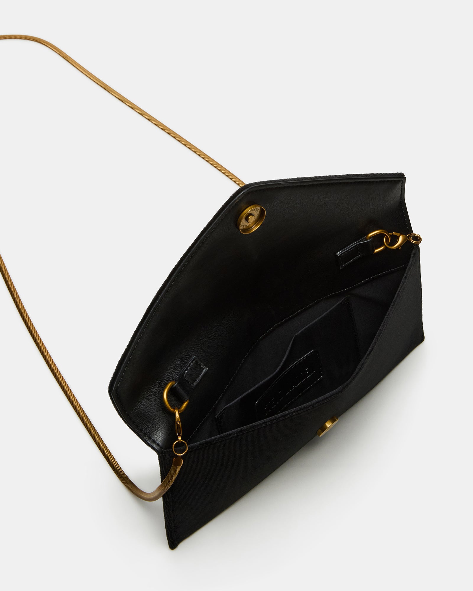 Close-up of the magnetic snap closure on the velvet clutch