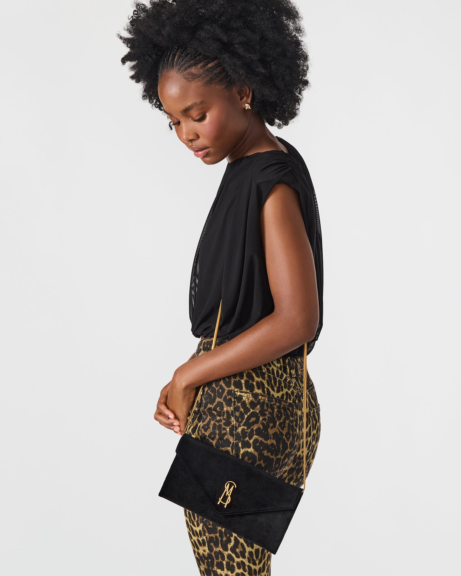 Close-up of the magnetic snap closure on the velvet clutch