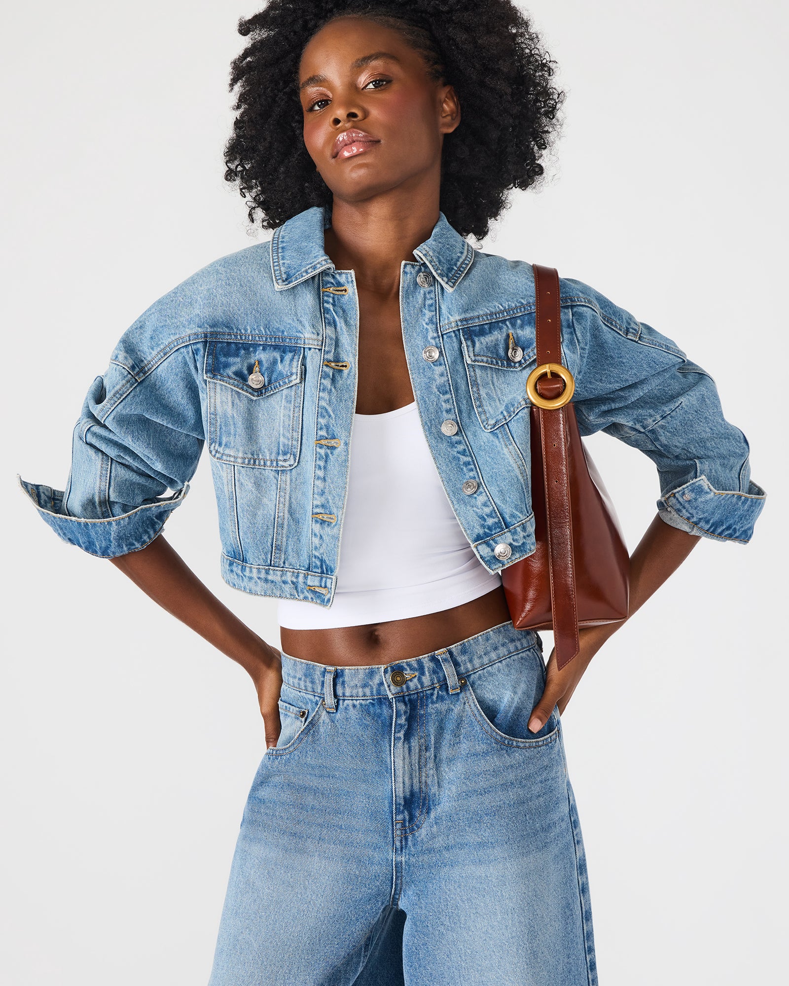 Rust leather shoulder bag with rounded hardware and magnetic snap closure, ideal for daily use
