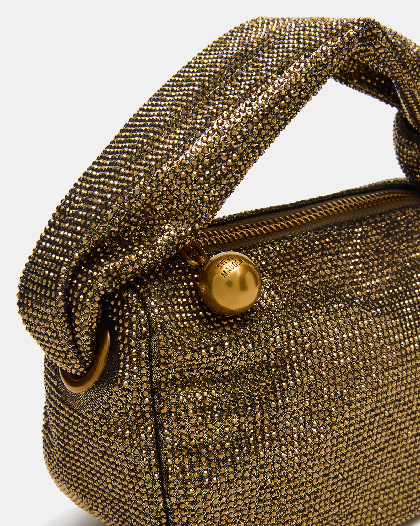 Side view of the top handle purse, highlighting its soft shape and compact size.
