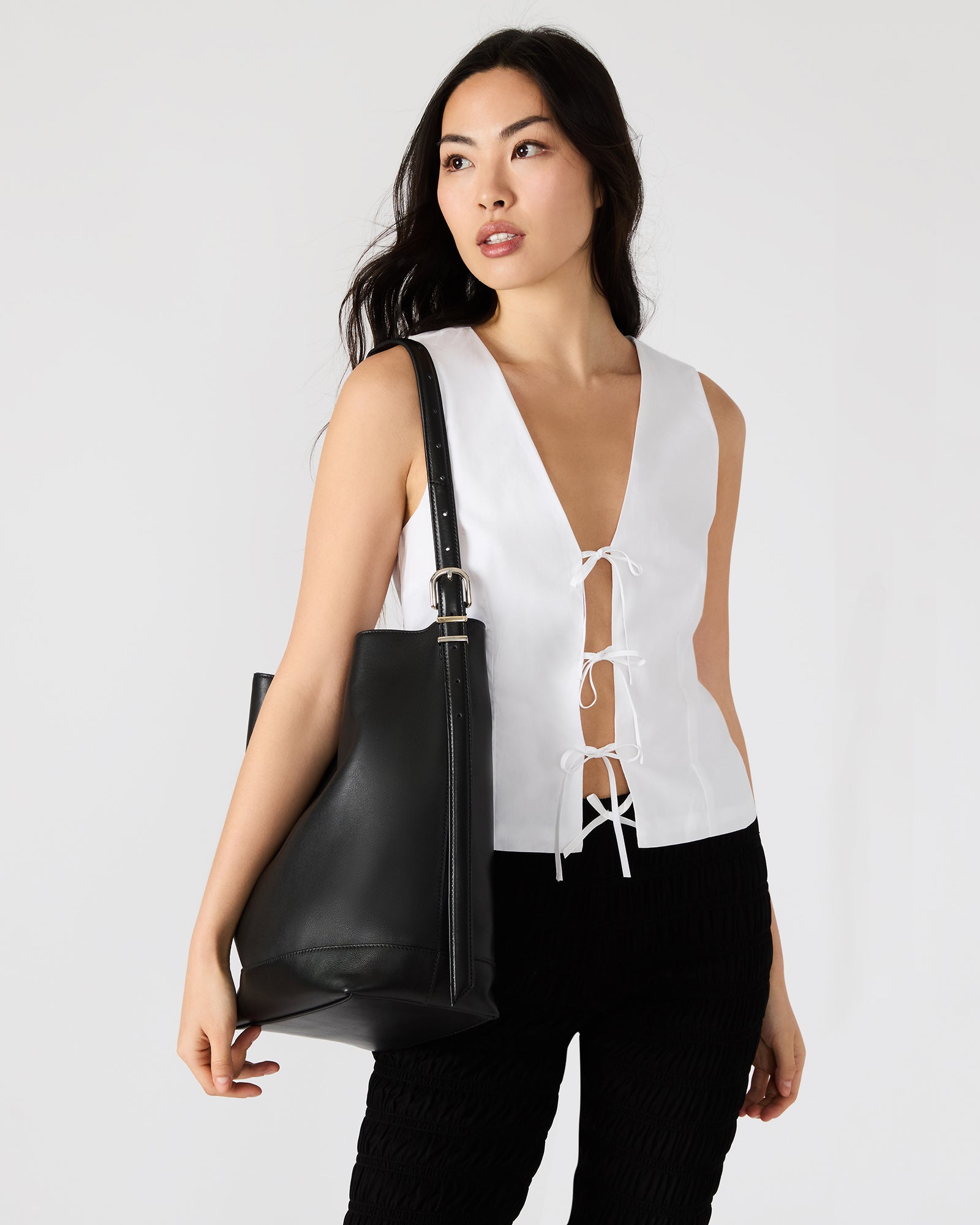 Styled image showing adjustable strap on Taylr crossbody bag