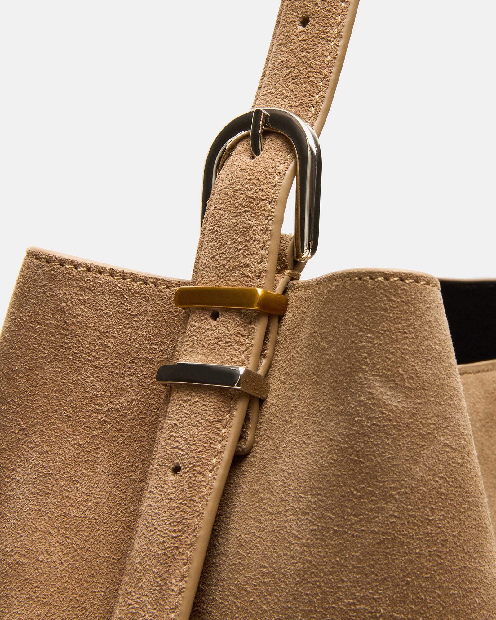 Close-up of two-tone hardware on taupe crossbody bag bags