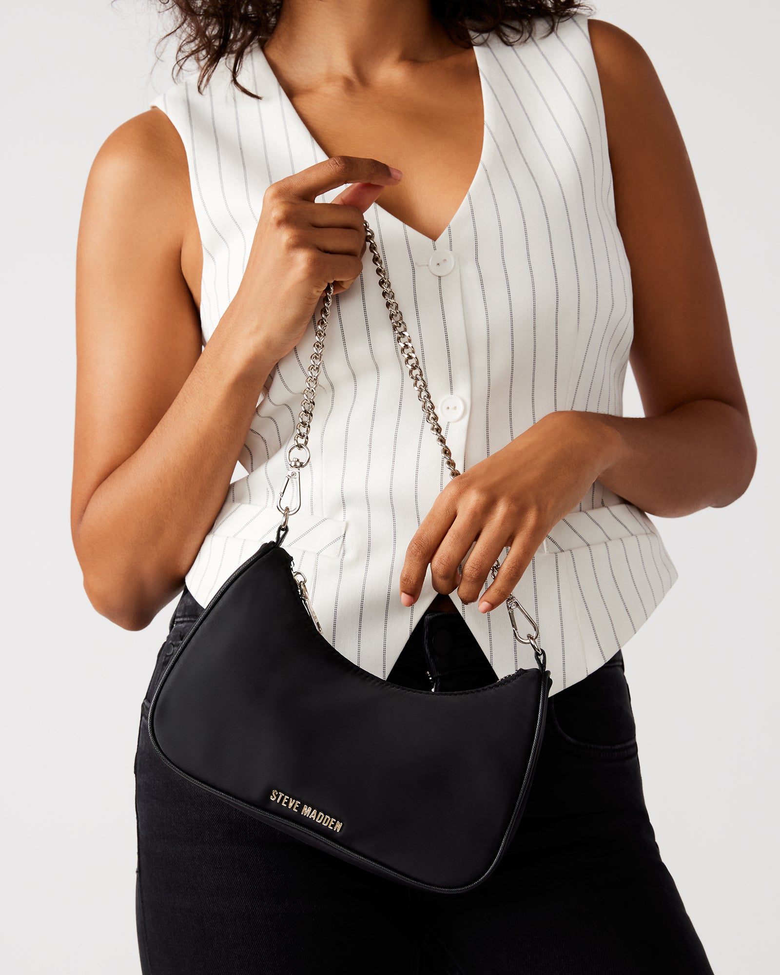 Elegant black handbag with silver chain detail, perfect for daily use.