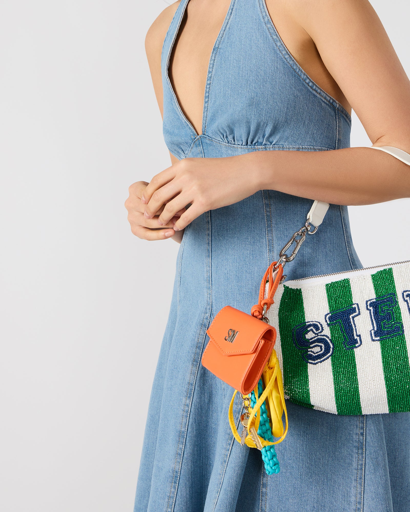 Soft satin pouch with the coach bag charm and summer camp-inspired lanyard for travel organization