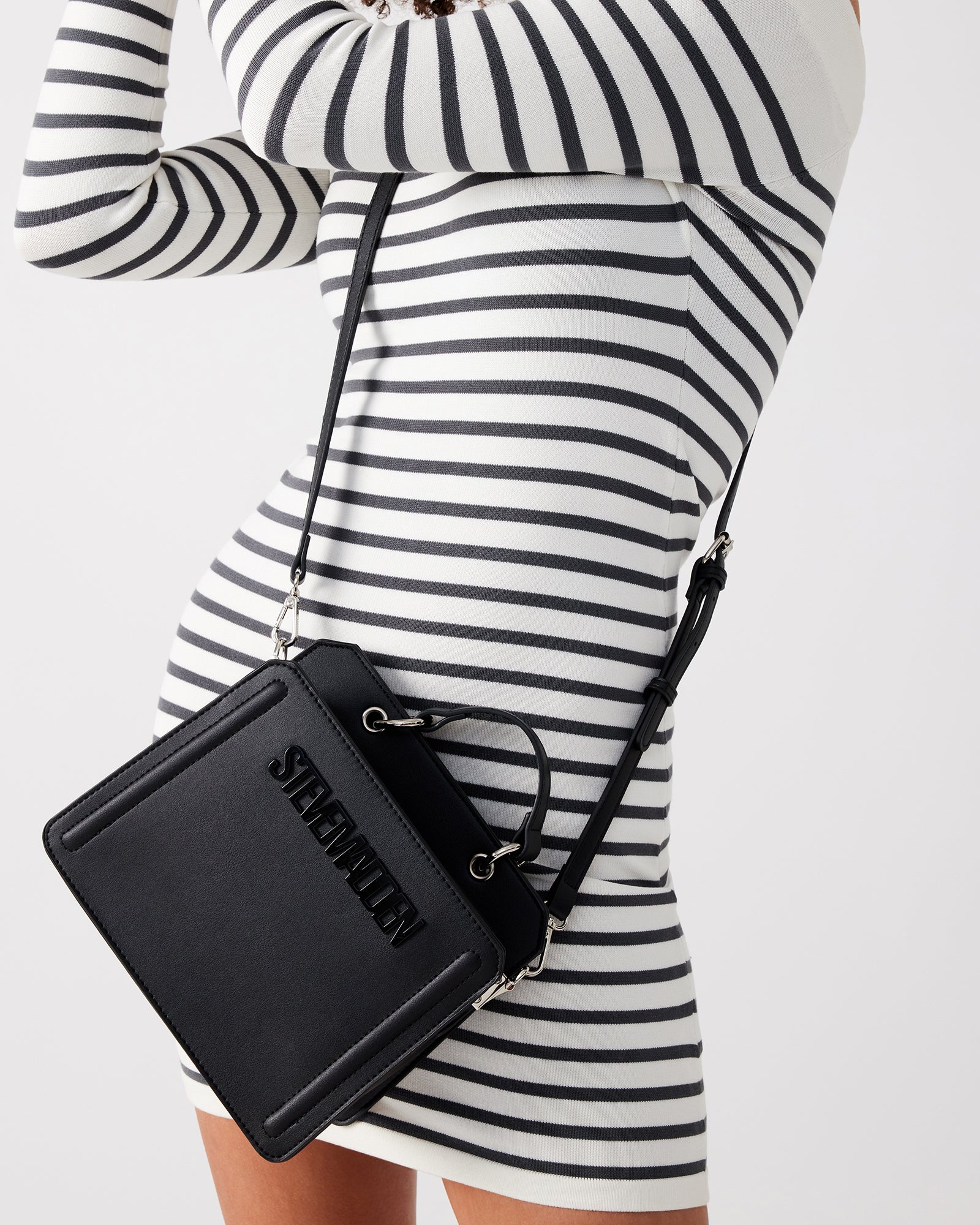 Model wearing the bag as a crossbody, showcasing its versatile urban appeal.