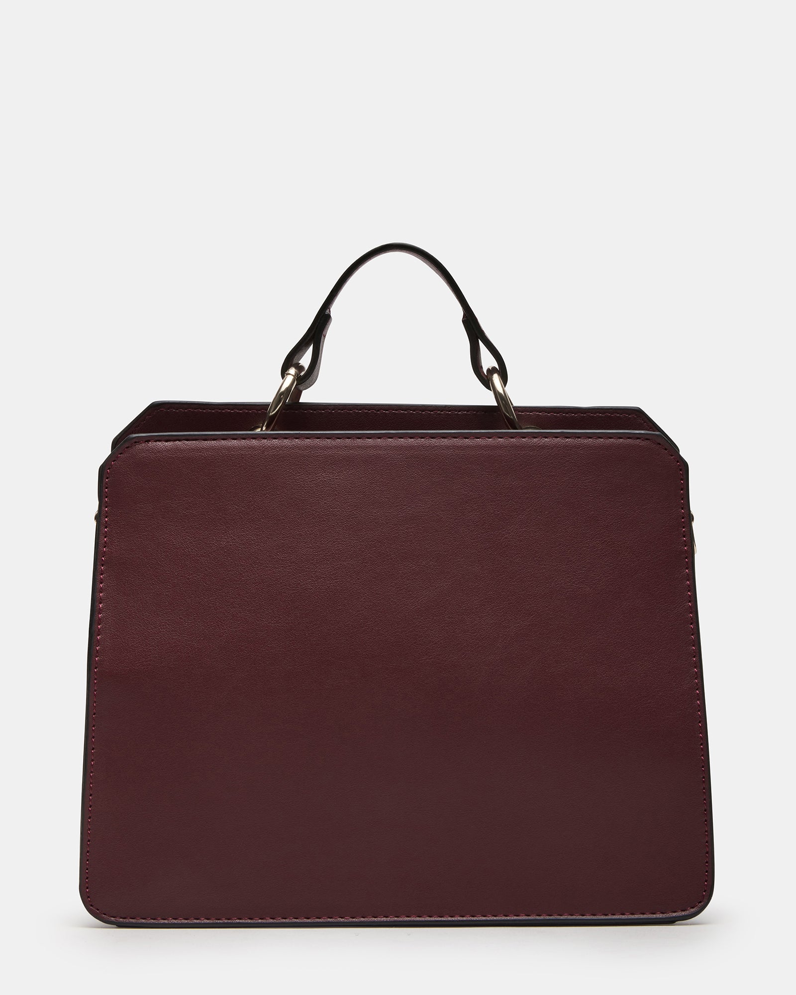 Close-up of the Evelyn bags oversized O-ring top handle hardware and snap closure.