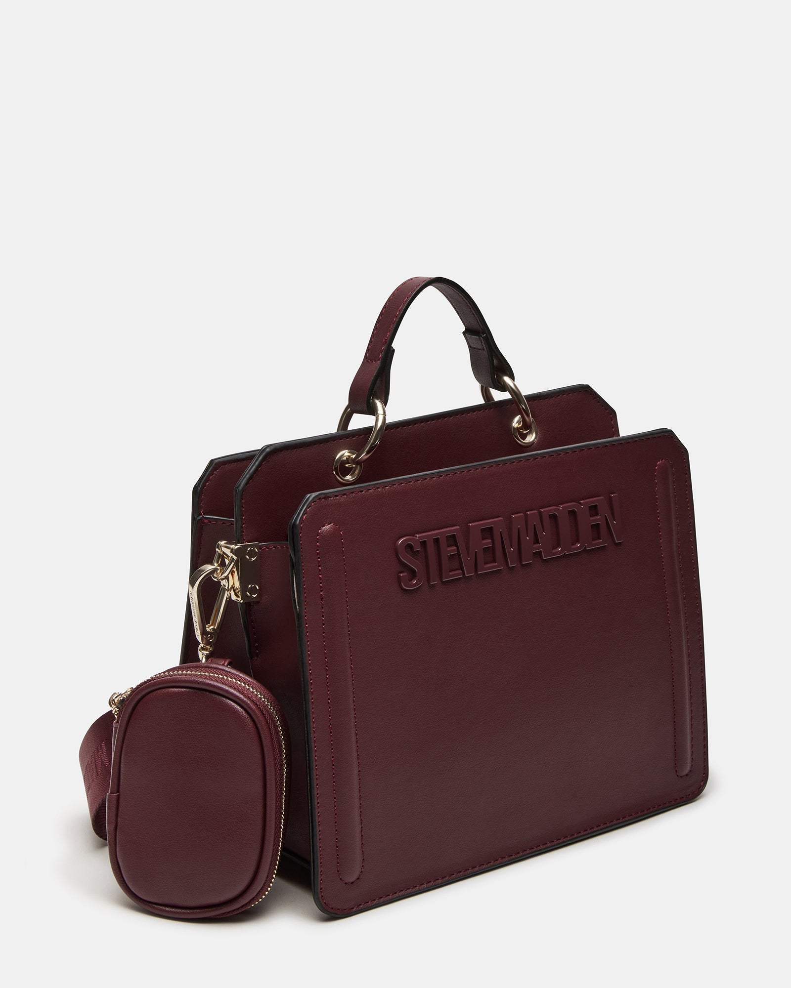 Close-up of the Evelyn bags oversized O-ring top handle hardware and snap closure.