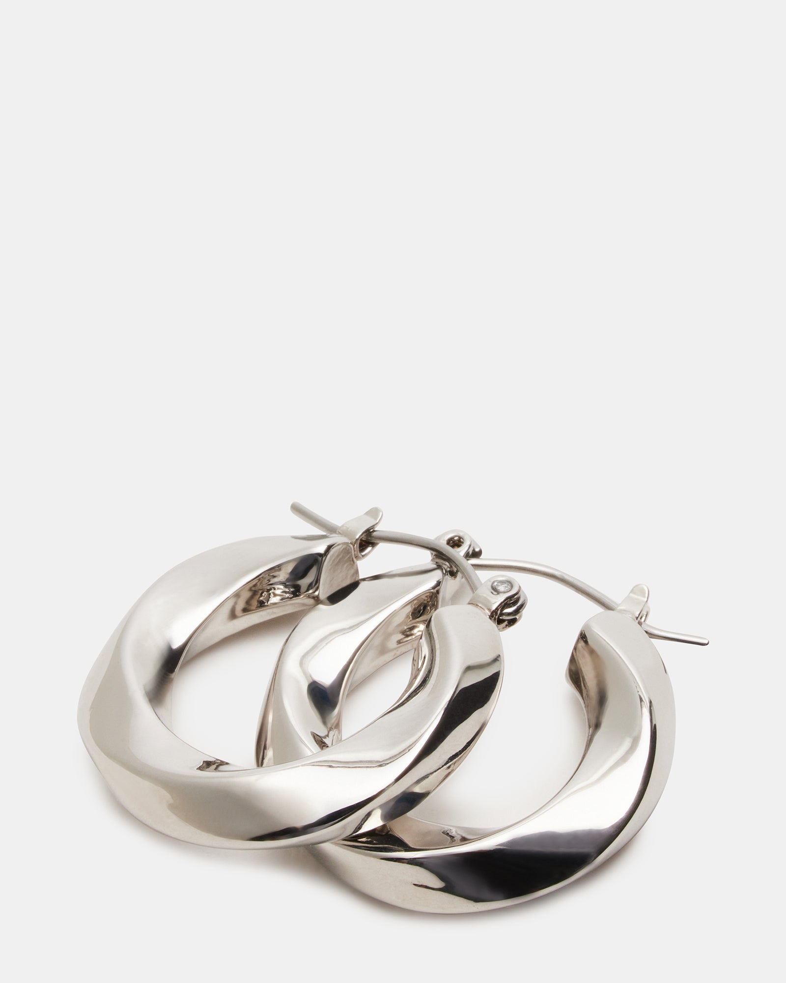 Twisted hoop earrings being worn, showing elegant profile
