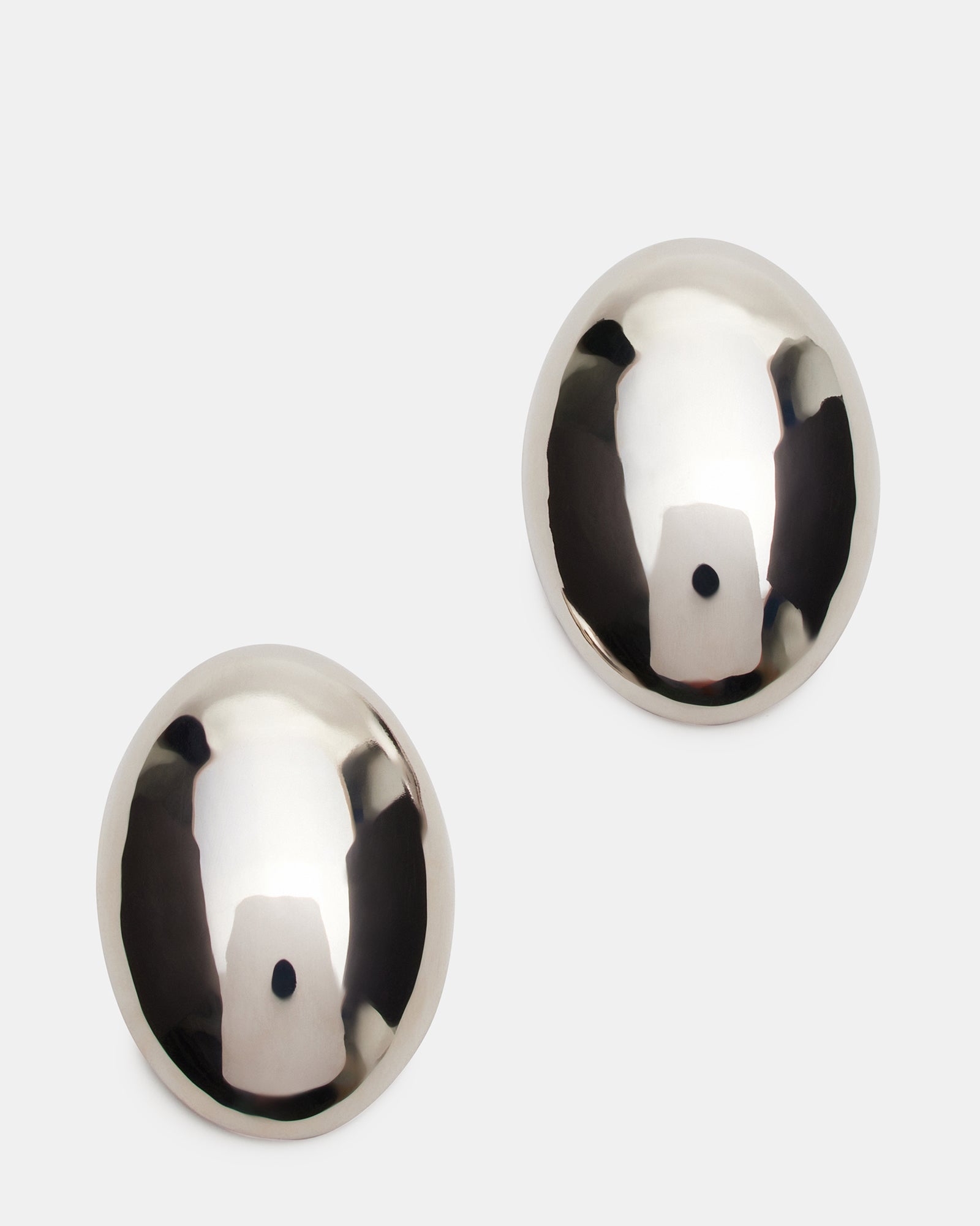 Close-up of elegant oval silver stud earrings on a white background.
