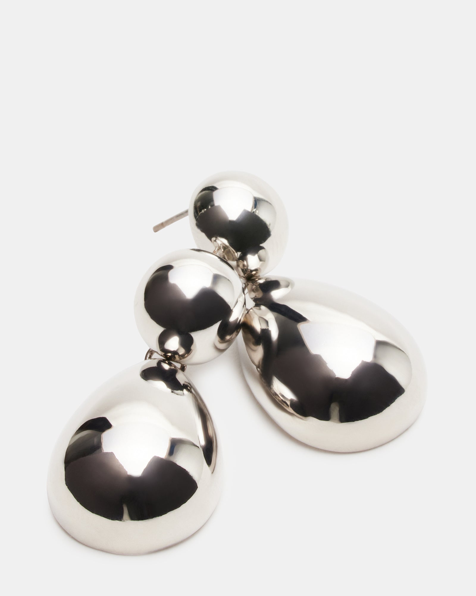 Model wearing silver double teardrop earrings with a chic outfit