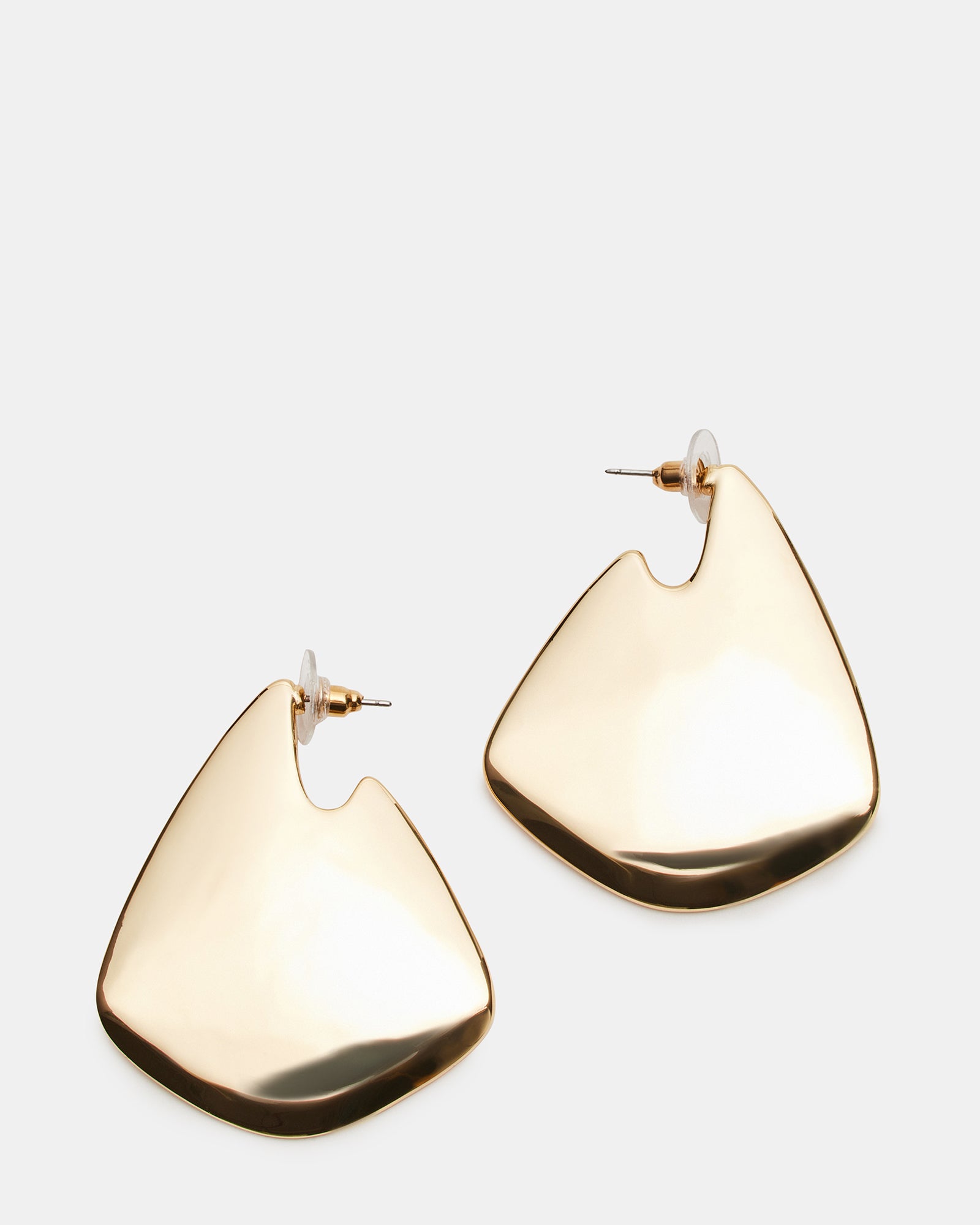 Side view of sculpted gold earrings showing geometric design