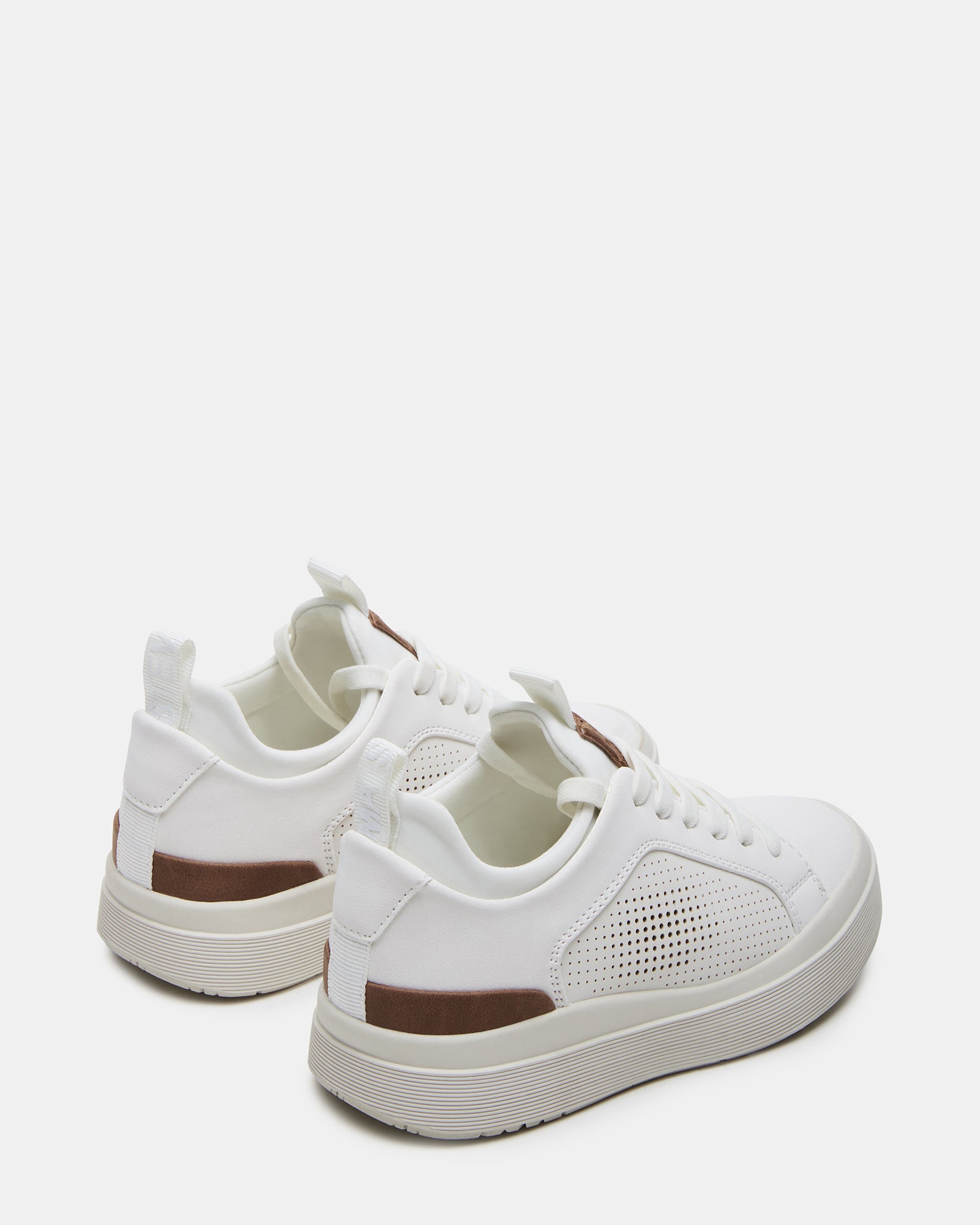 Close-up of vegan leather material and stitching on white kid shoes